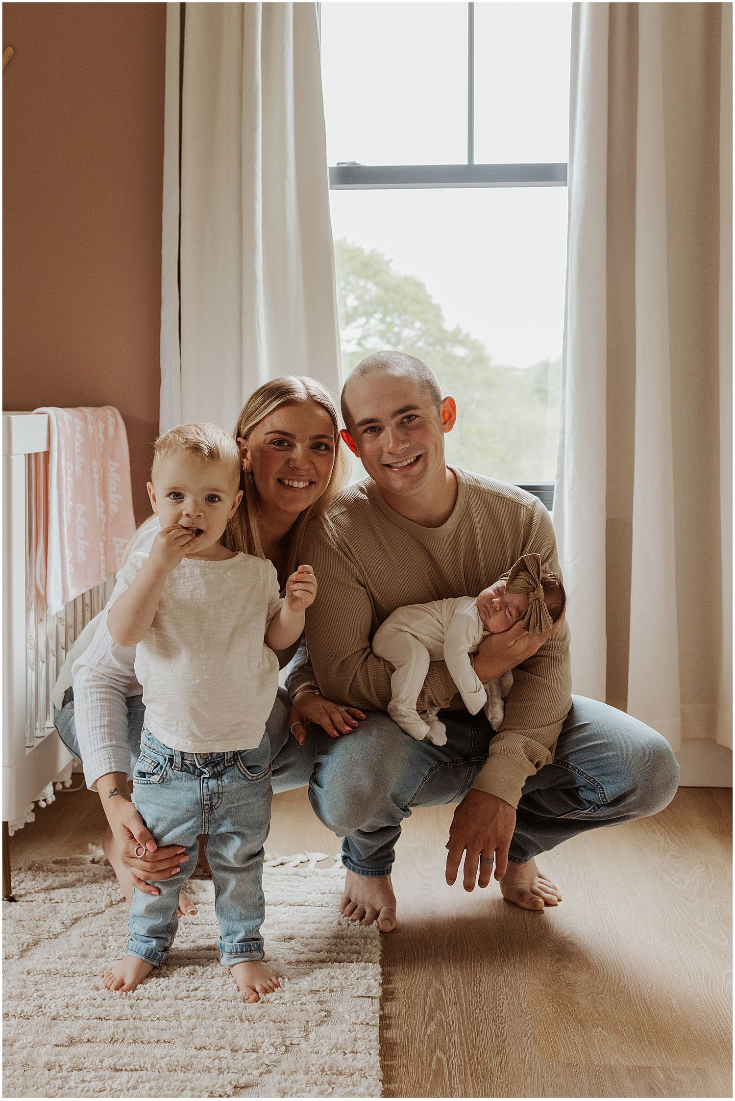 NH family taking lifestyle newborn family photos at home