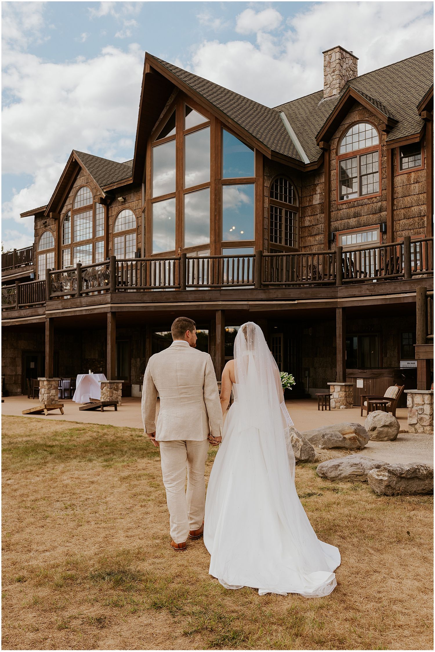 Bride and groom walking the property at their VRBO wedding in Maine