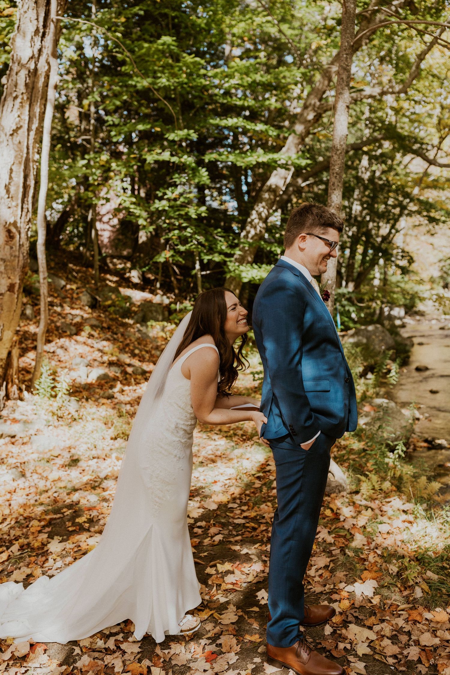 Briana squeezing Daniel's butt to signal that he can turn around and see her now.
