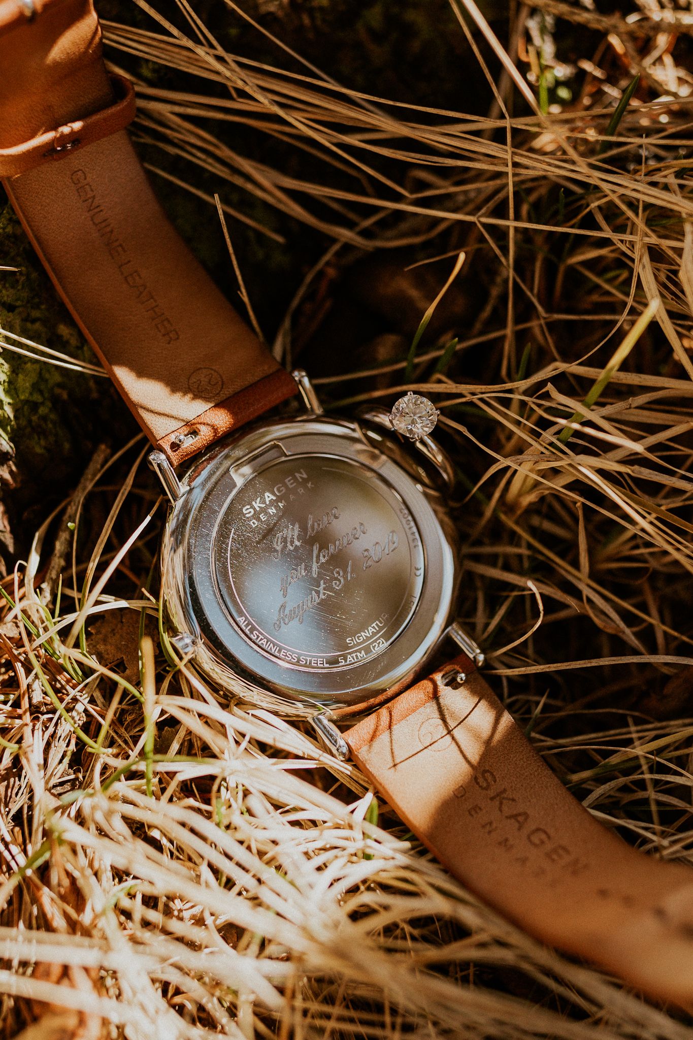 Her engagement ring with his engraved watch. A symbol of the couples love.