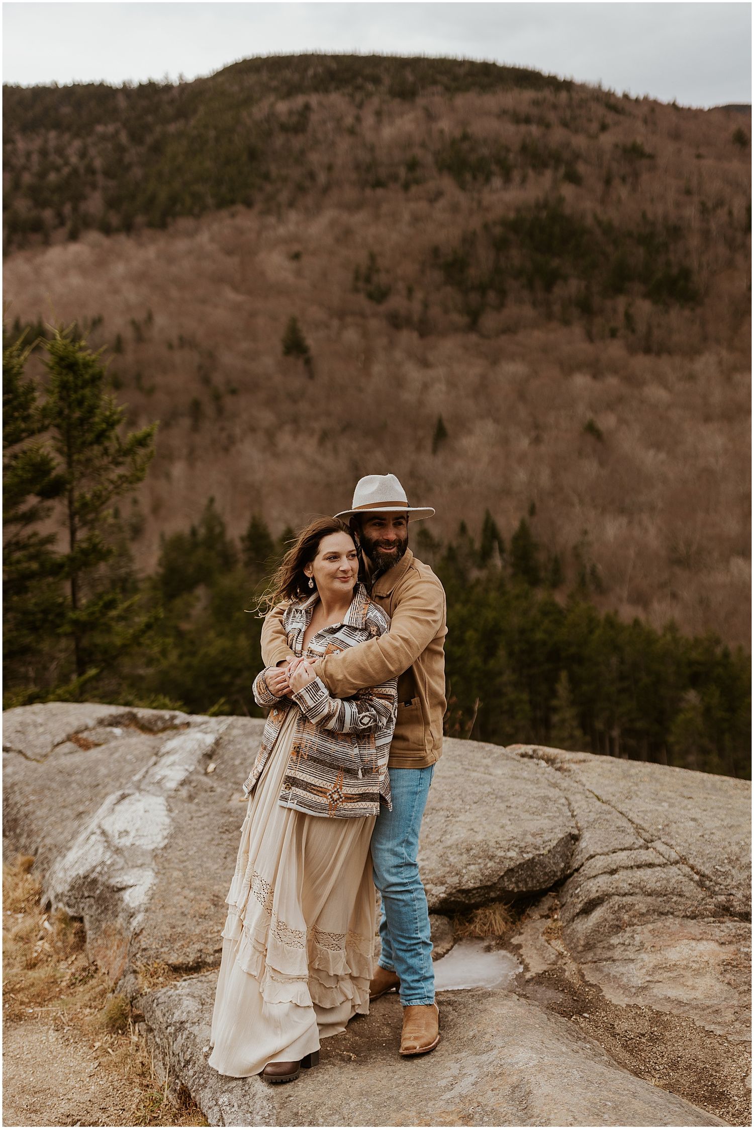 Couple taking boho engagement photos in the NH White Mountains