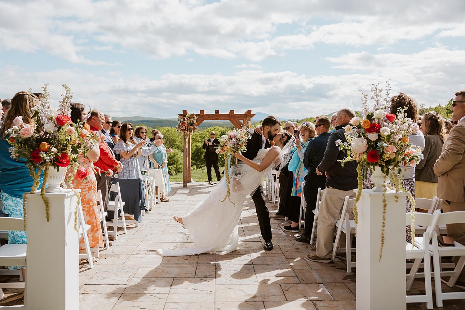 Bride and groom kissing after their NH wedding ceremony at Longlook Farm