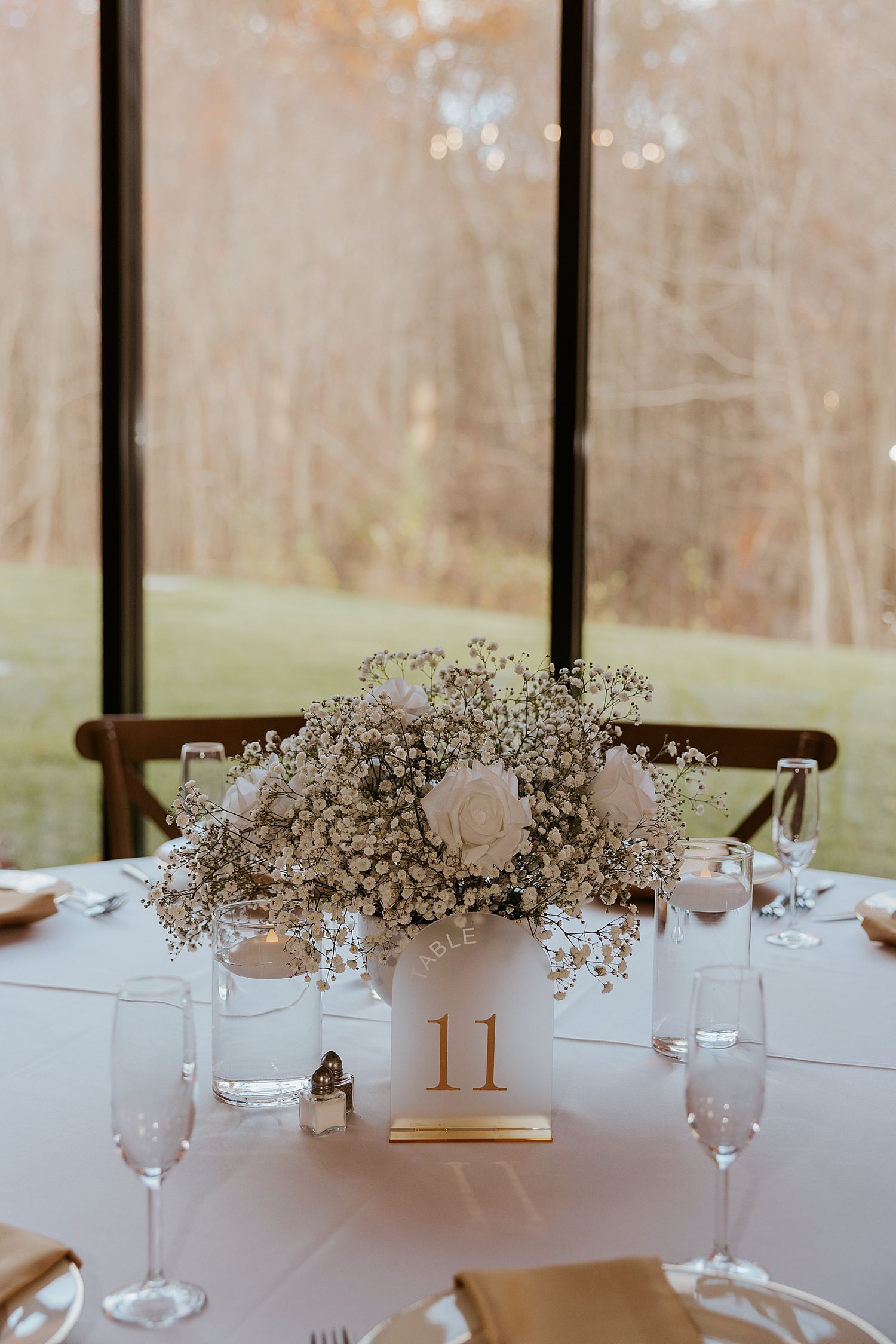 Baby's breath and white flower floral arrangement for a Hyla Brook Estate wedding reception