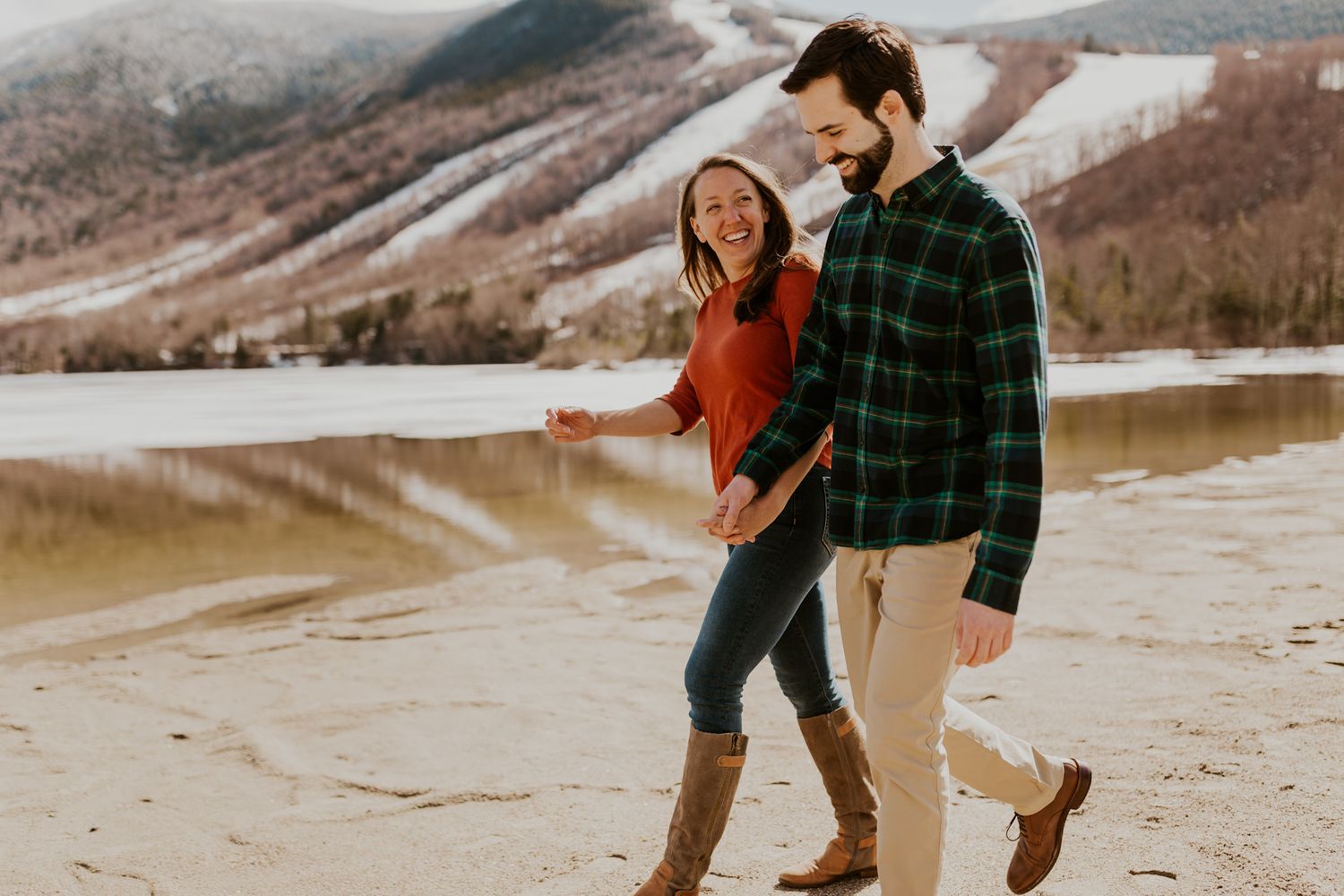 A happy couple walking in front of Echo Lake in Franconia Notch State Park