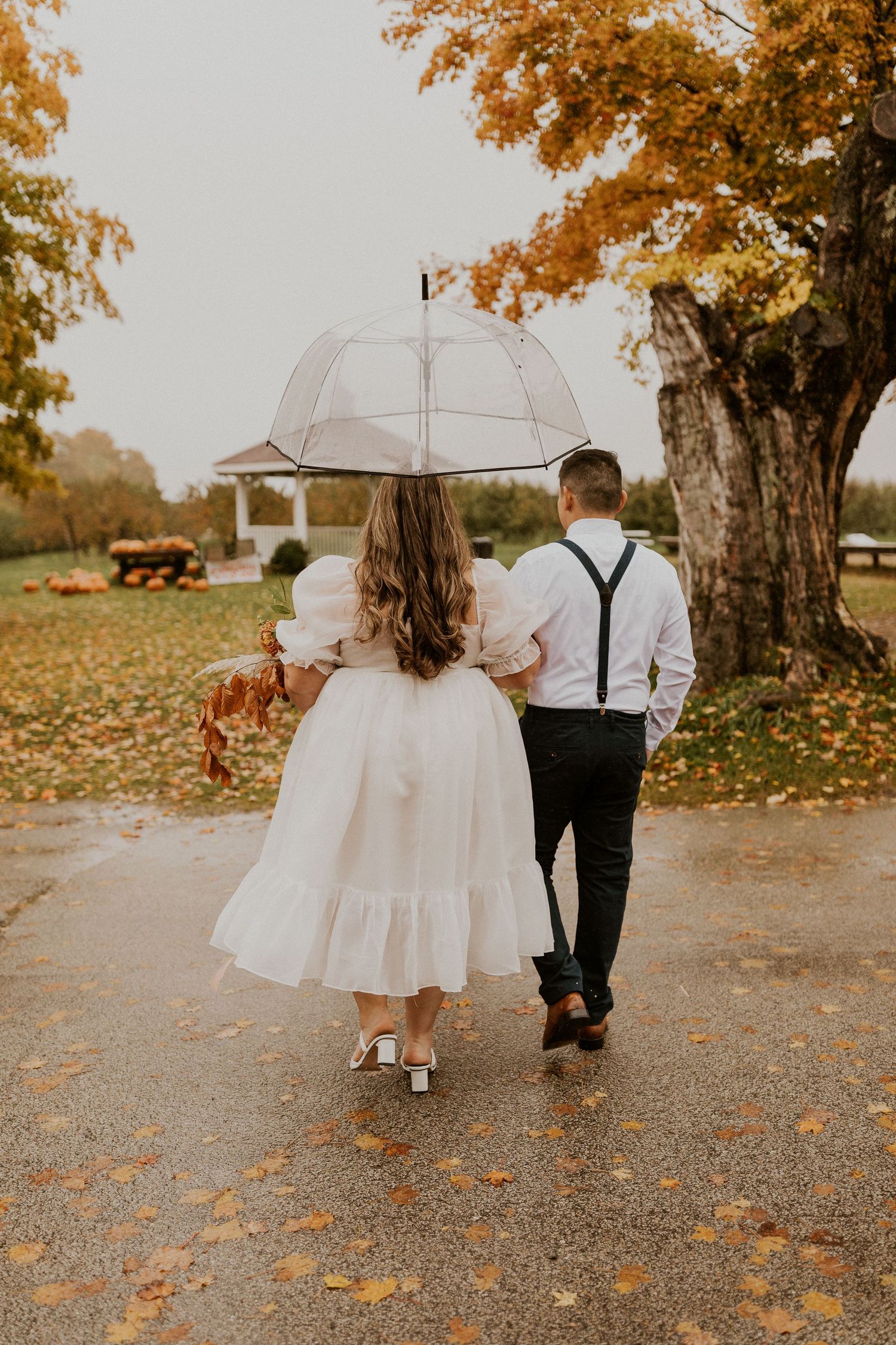 Terise and Jose walking to the gazebo at Carter Hill Orchard where they had their elopement.