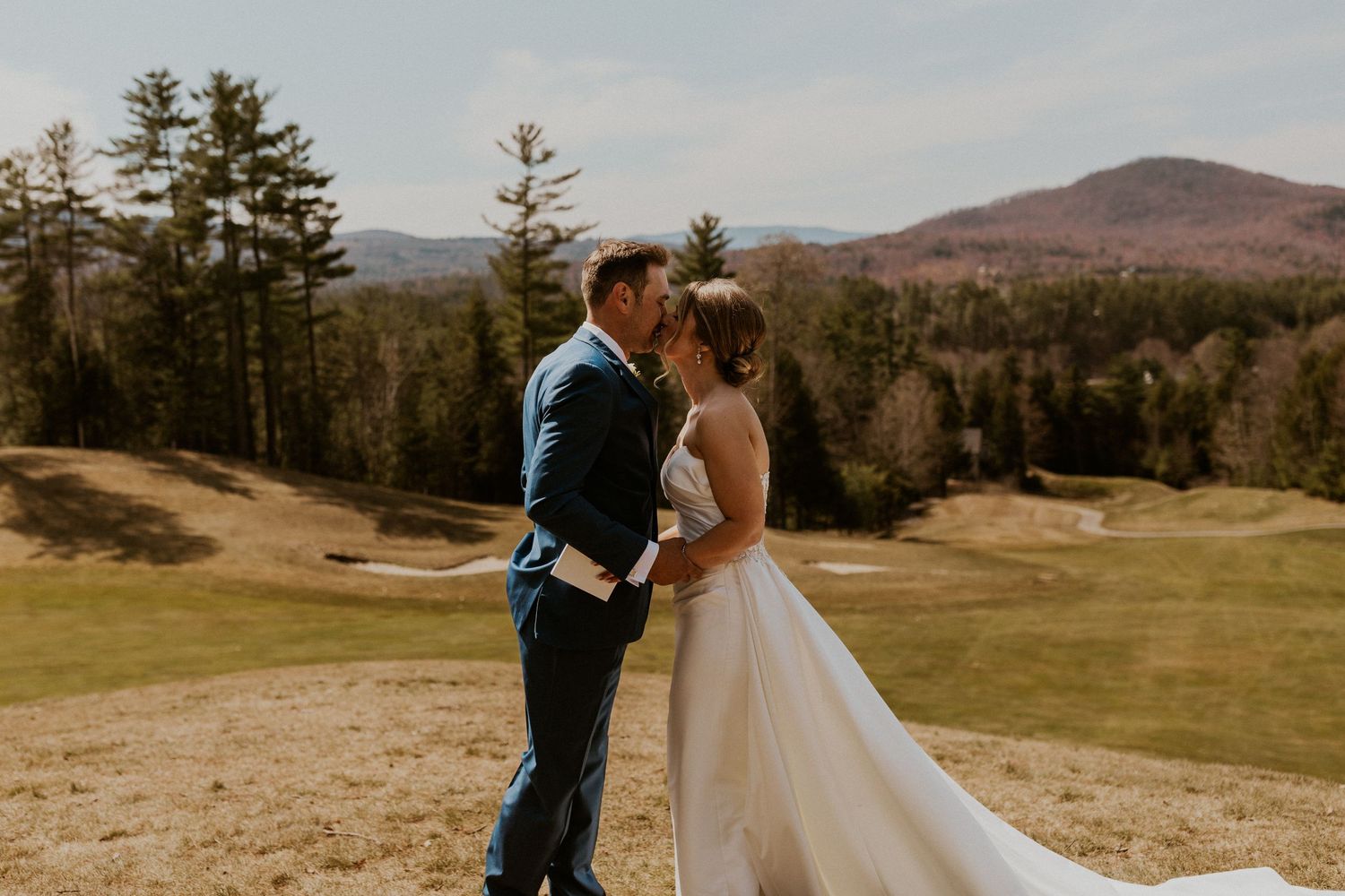 Kendra and Andrew sharing a kiss after privately reading their vows together in the scenic white mountains.