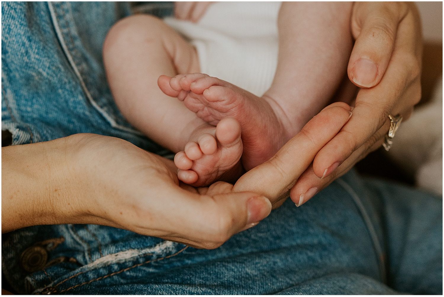 New Hampshire mom holding her newborn baby while taking lifestyle newborn photos