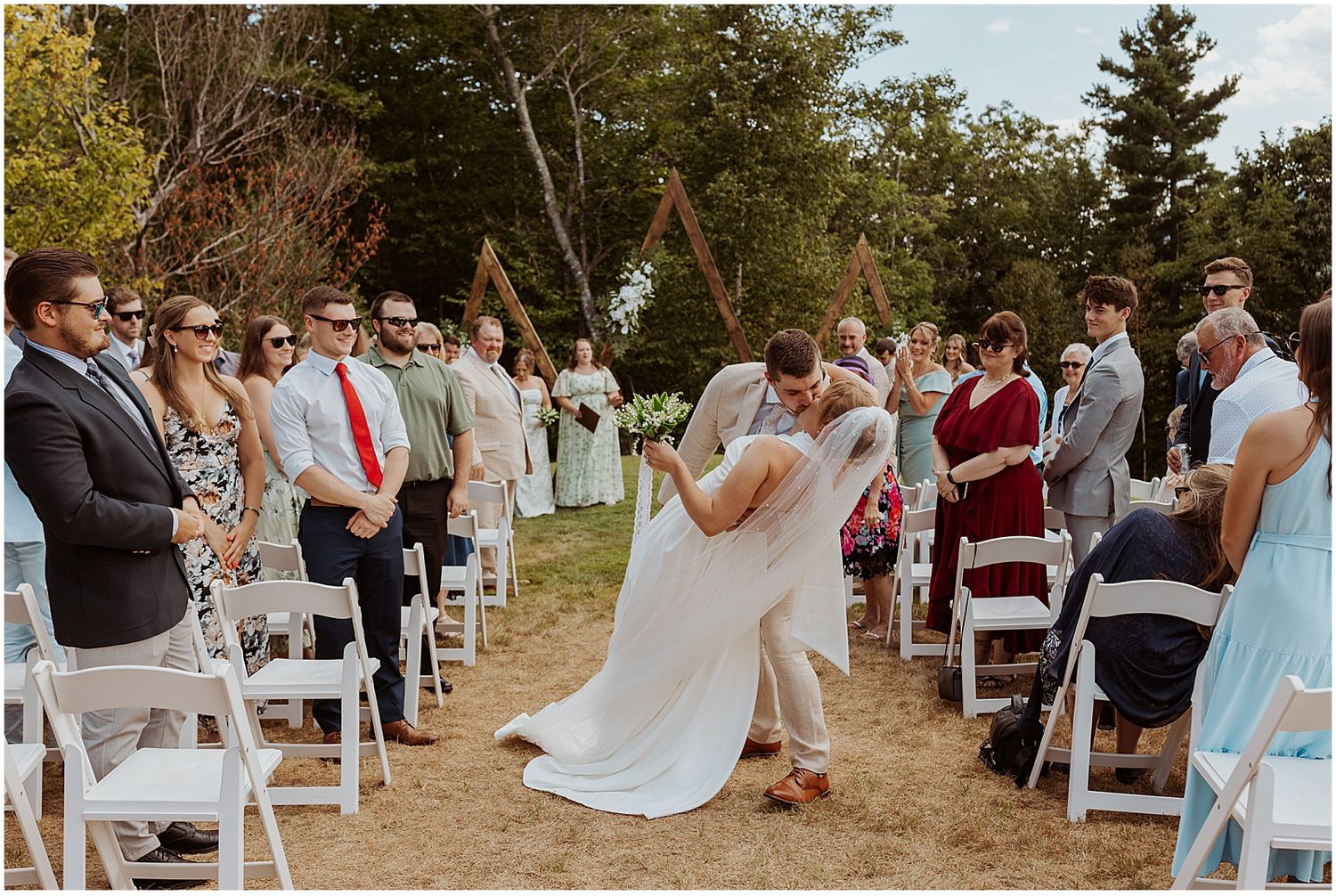 Bride and groom kissing at their Maine wedding ceremony