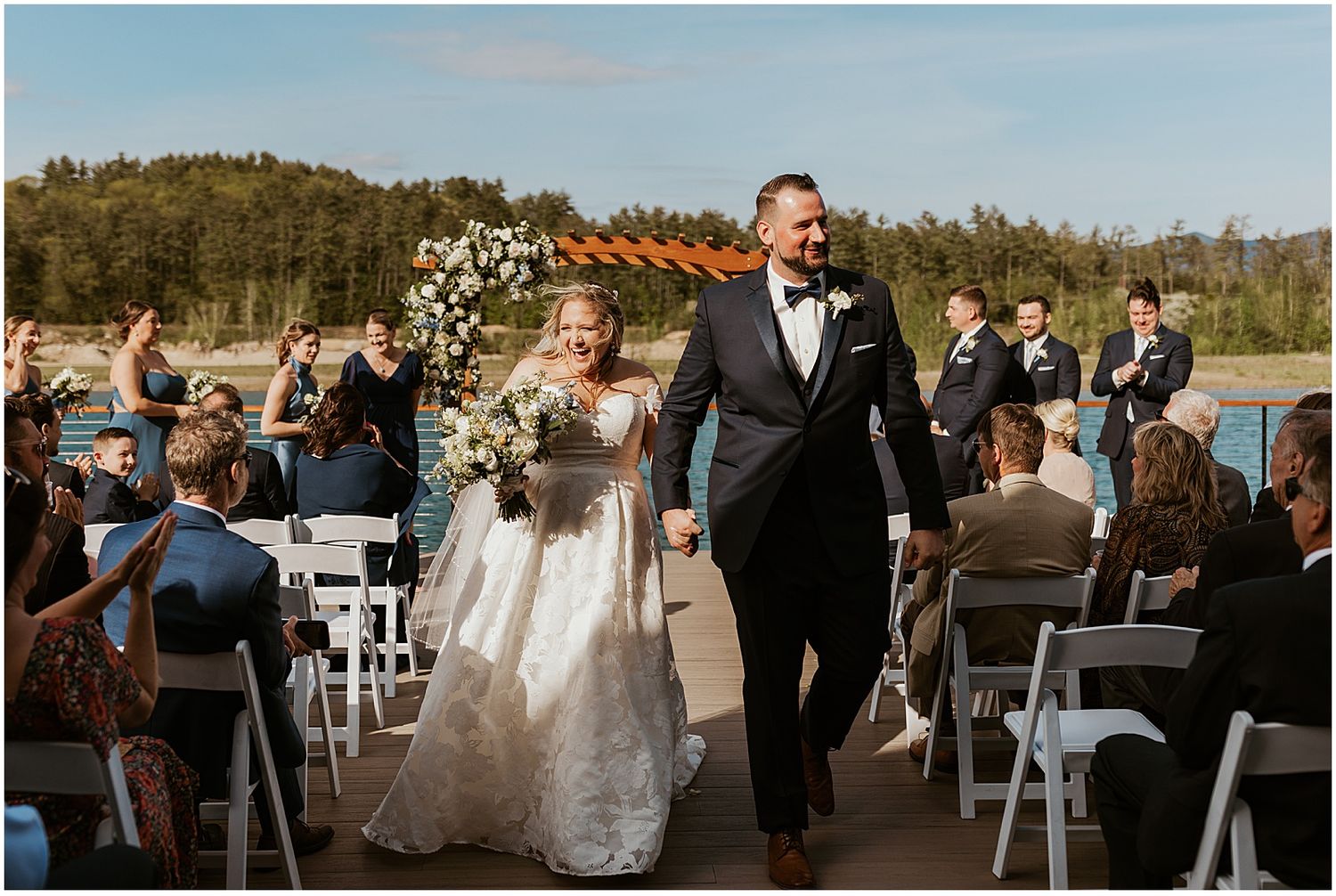 Bride and groom at their wedding ceremony on the lake at Owl's Nest NH