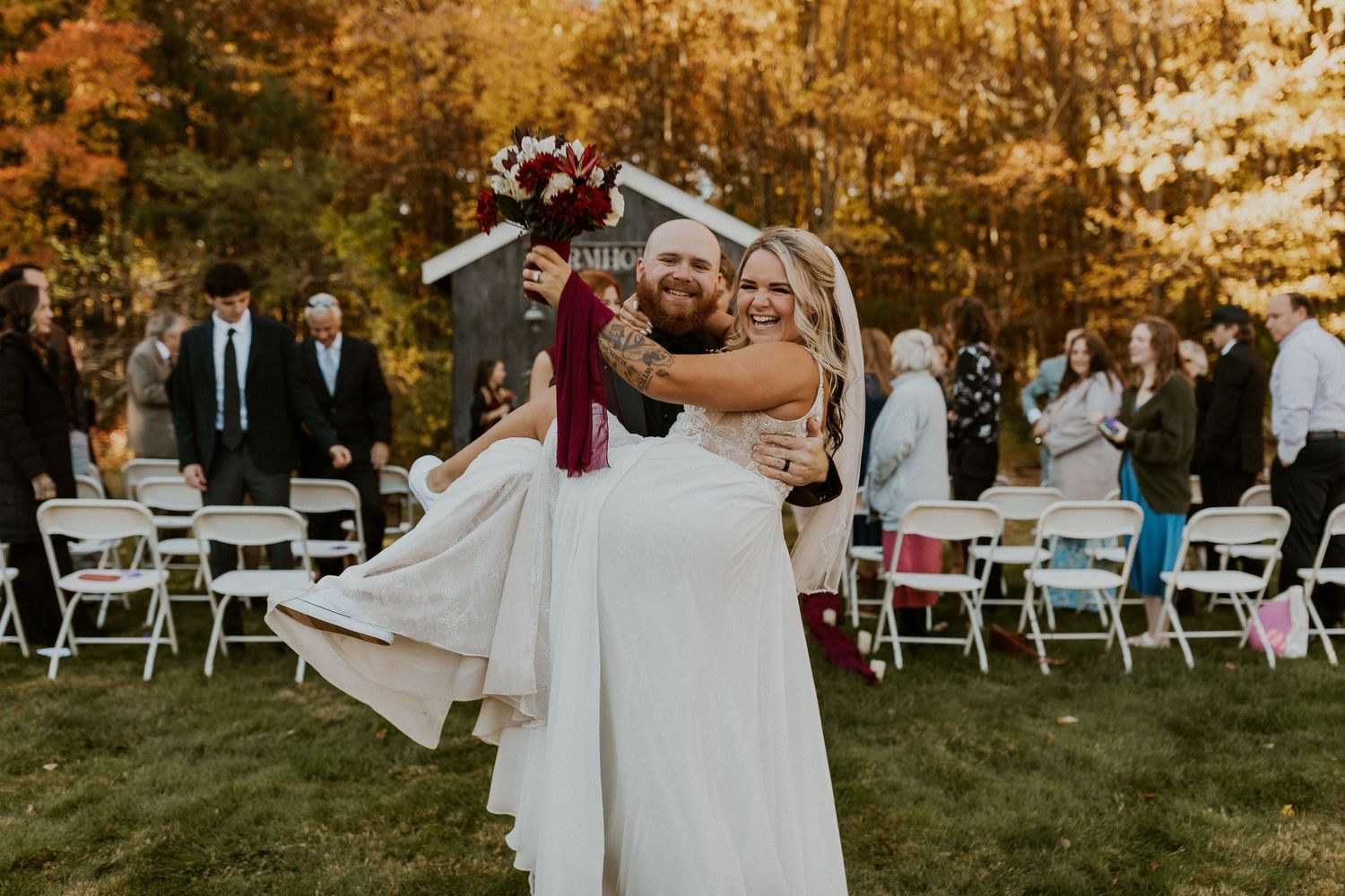 Bride and Groom celebrating as they walk out of their wedding ceremony in New Hampshire.