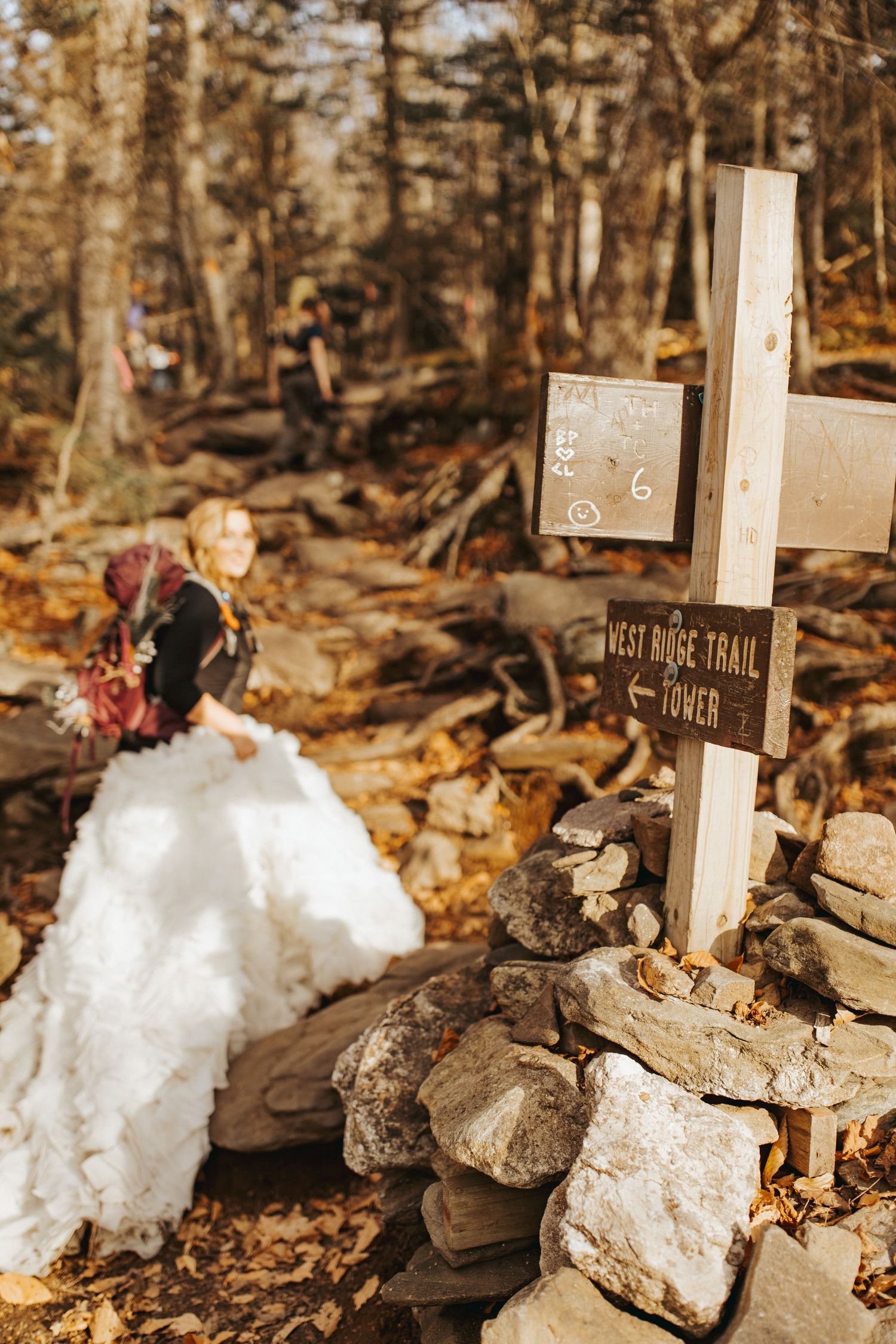 Jackie and Andy Brosonski hike the West Ridge Trail on Mount Cardigan in their wedding attire.