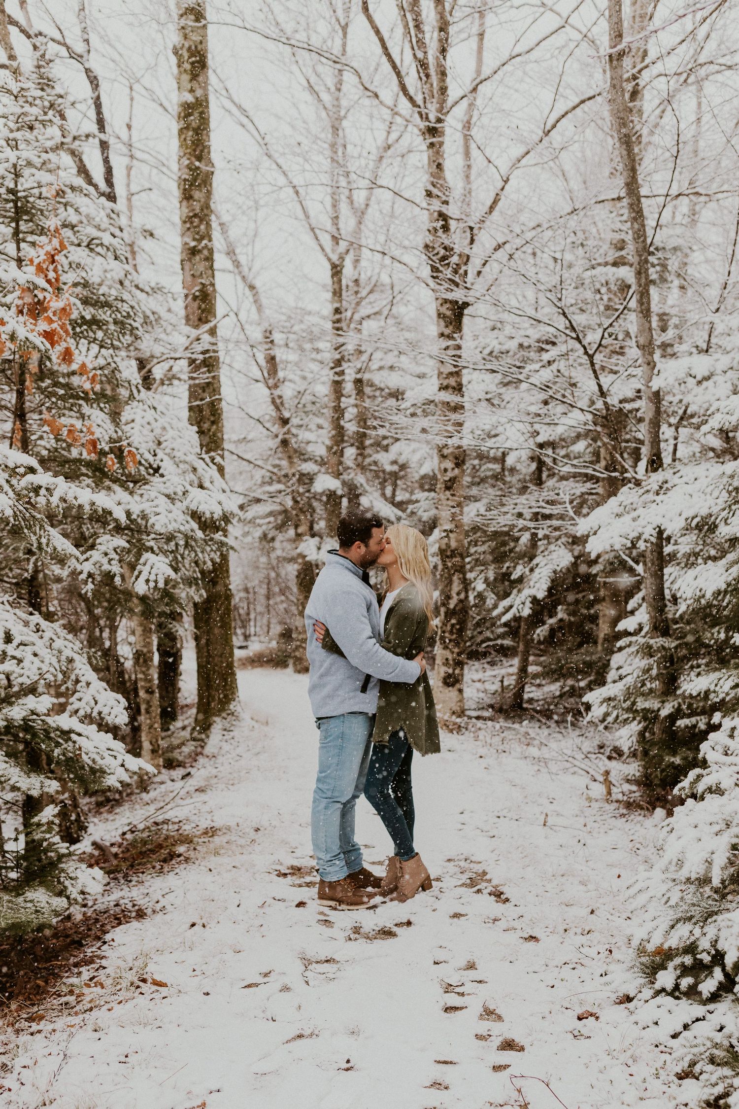 Newly engaged couple playfully posing for photos during their engagement session in Franconia New Hampshire.
