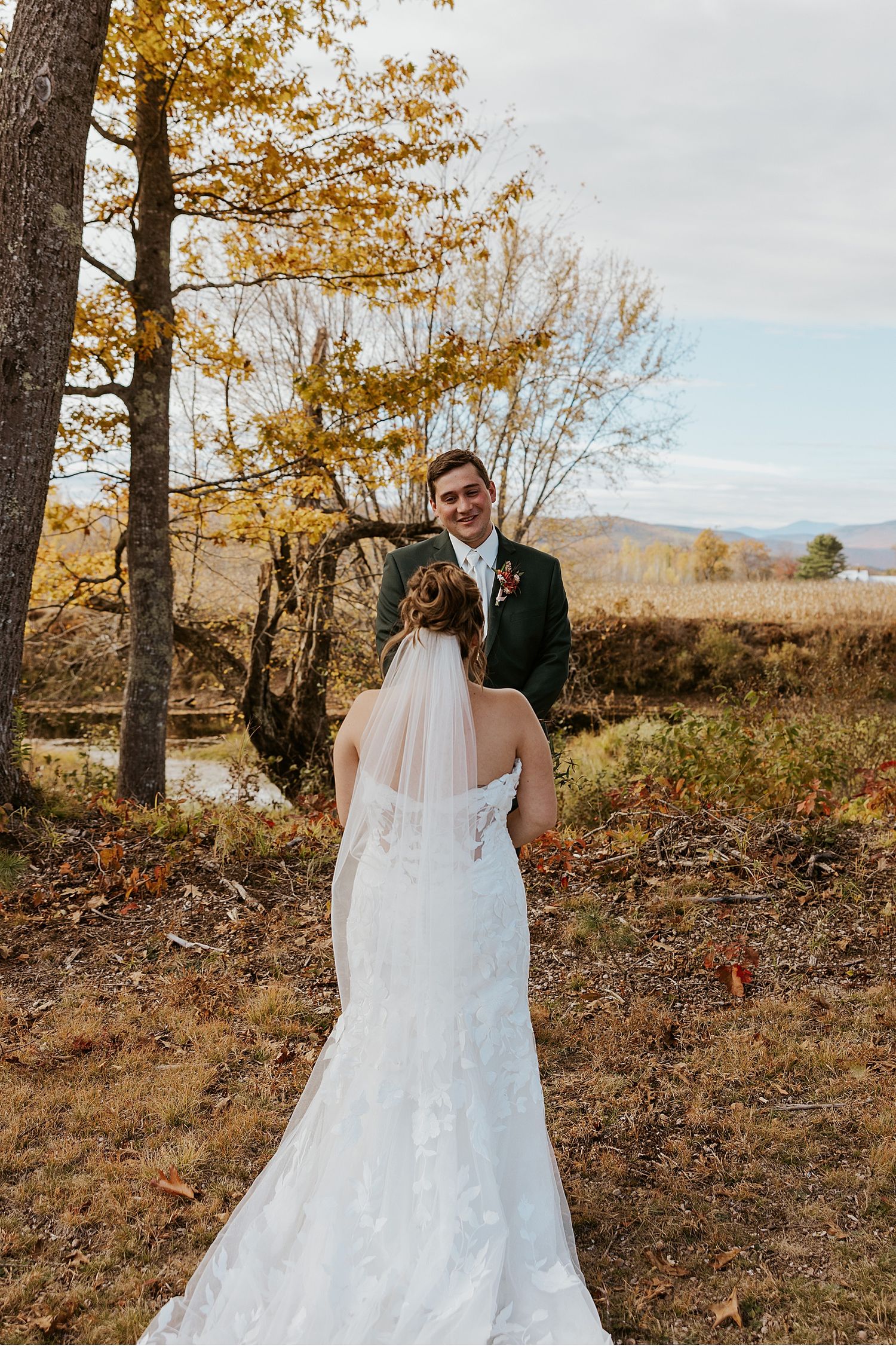 Bride and groom taking first look wedding photos at their NH wedding