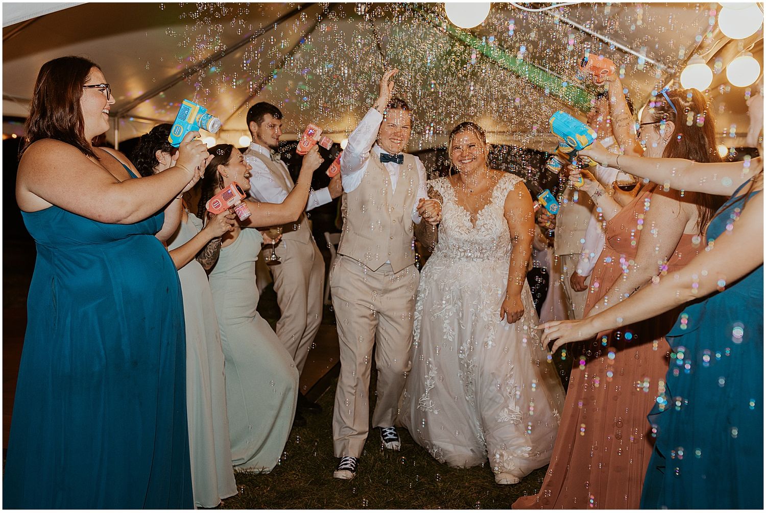 Wedding reception celebration with blue and white confetti falling under string lights.