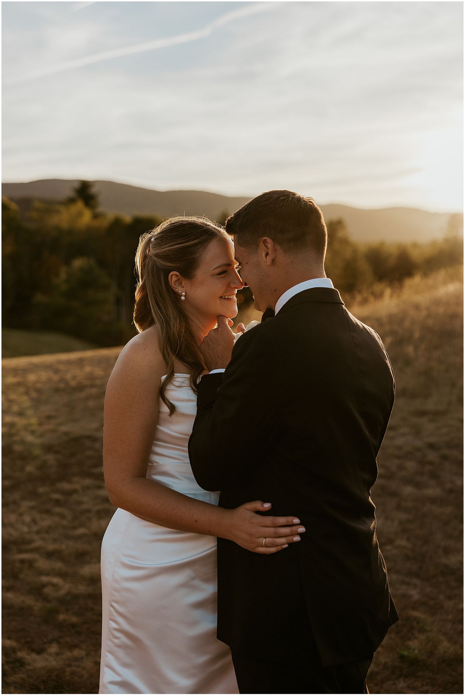 Bride and groom taking sunset photos at their White Mountain wedding
