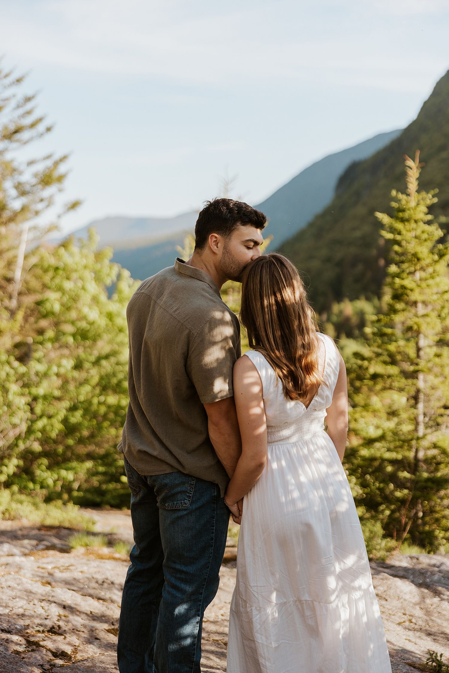 Couple taking golden hour engagement photos in the White Mountains in NH