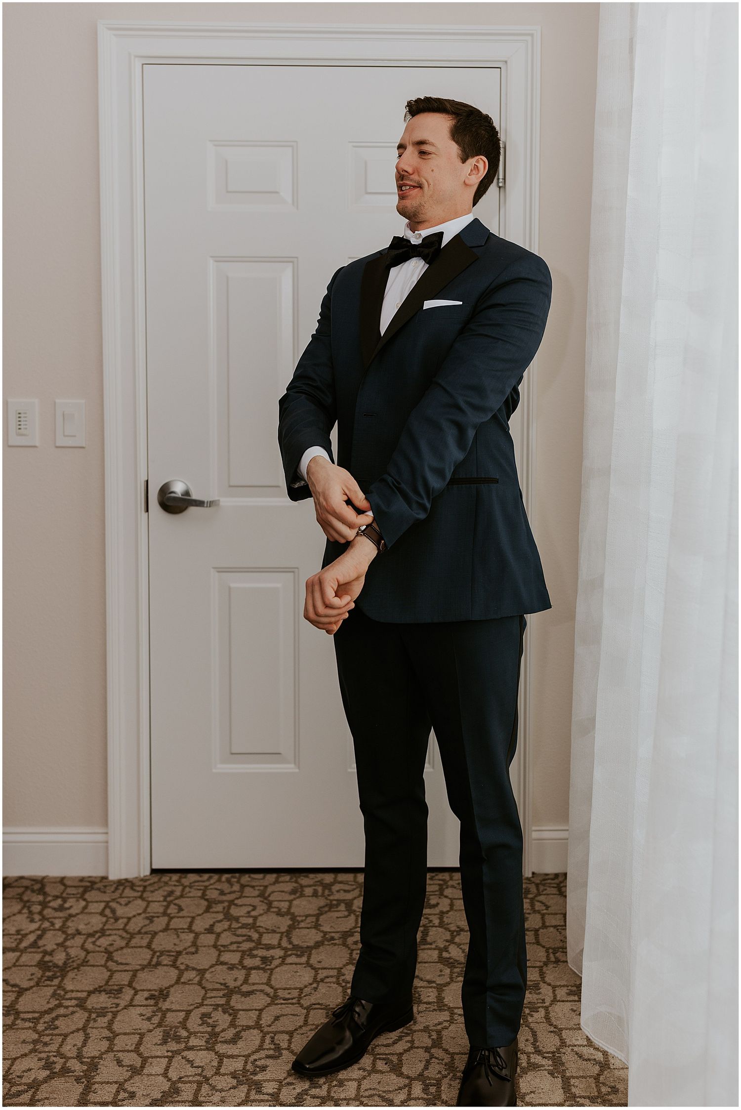 Groom getting dressed for his Loon Mountain wedding at River Walk Resort