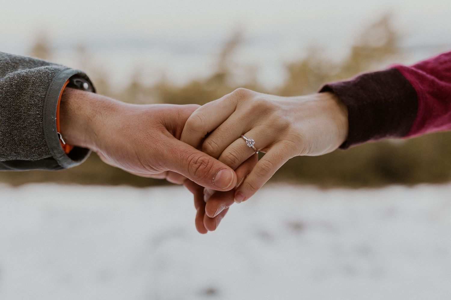 A closeup photograph of Ivan and Kirsten's hands displaying Kirsten's new engagement ring.