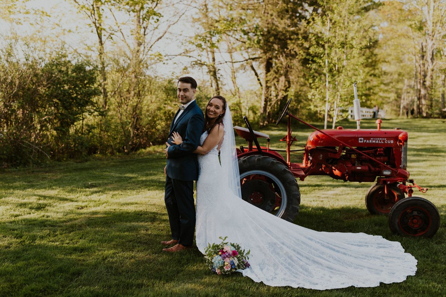 Chrissy embracing Mike for a portrait. The tractor is in the background.