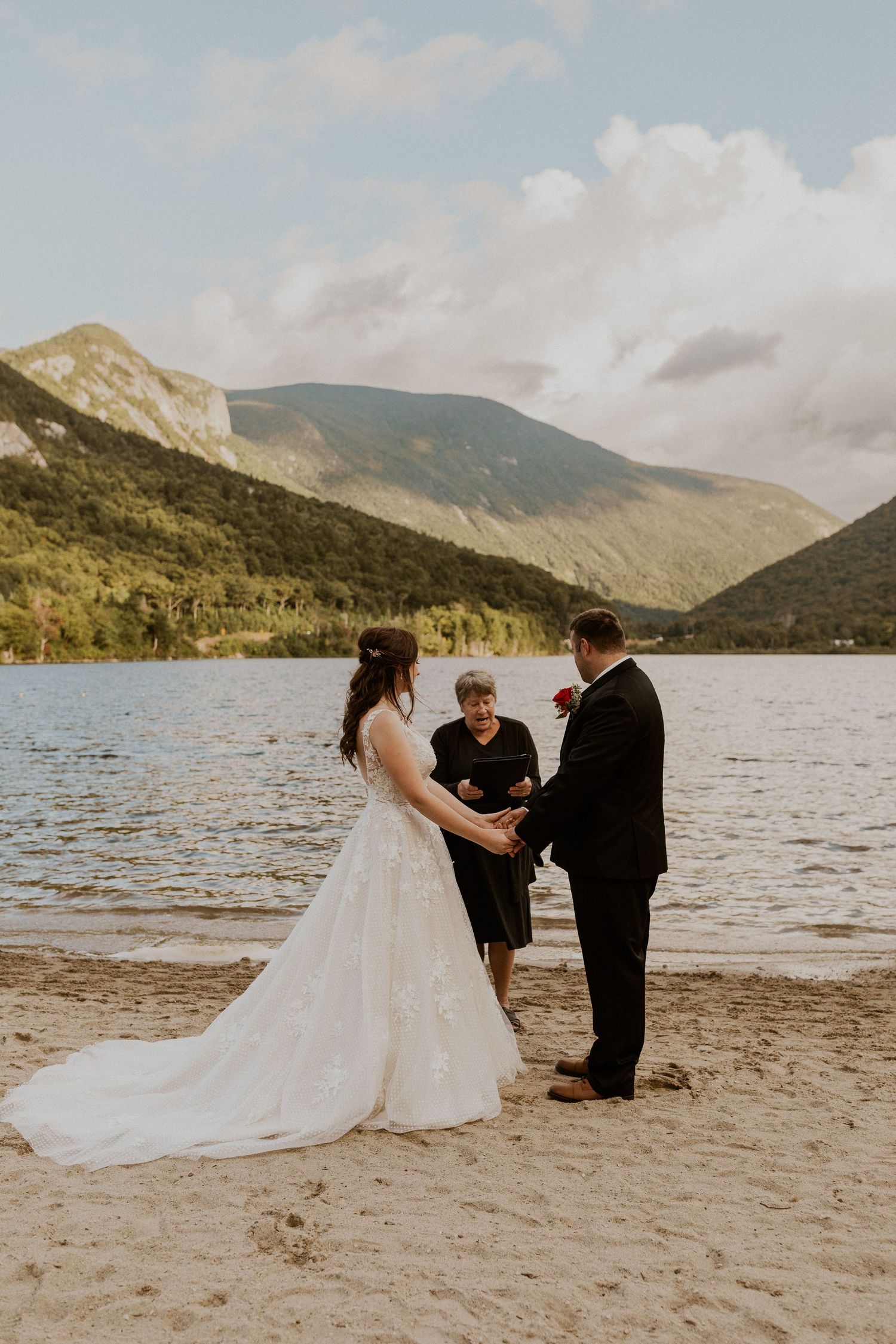 Bride and groom hold hands in front of the justice of the peace while declaring their love to each other.
