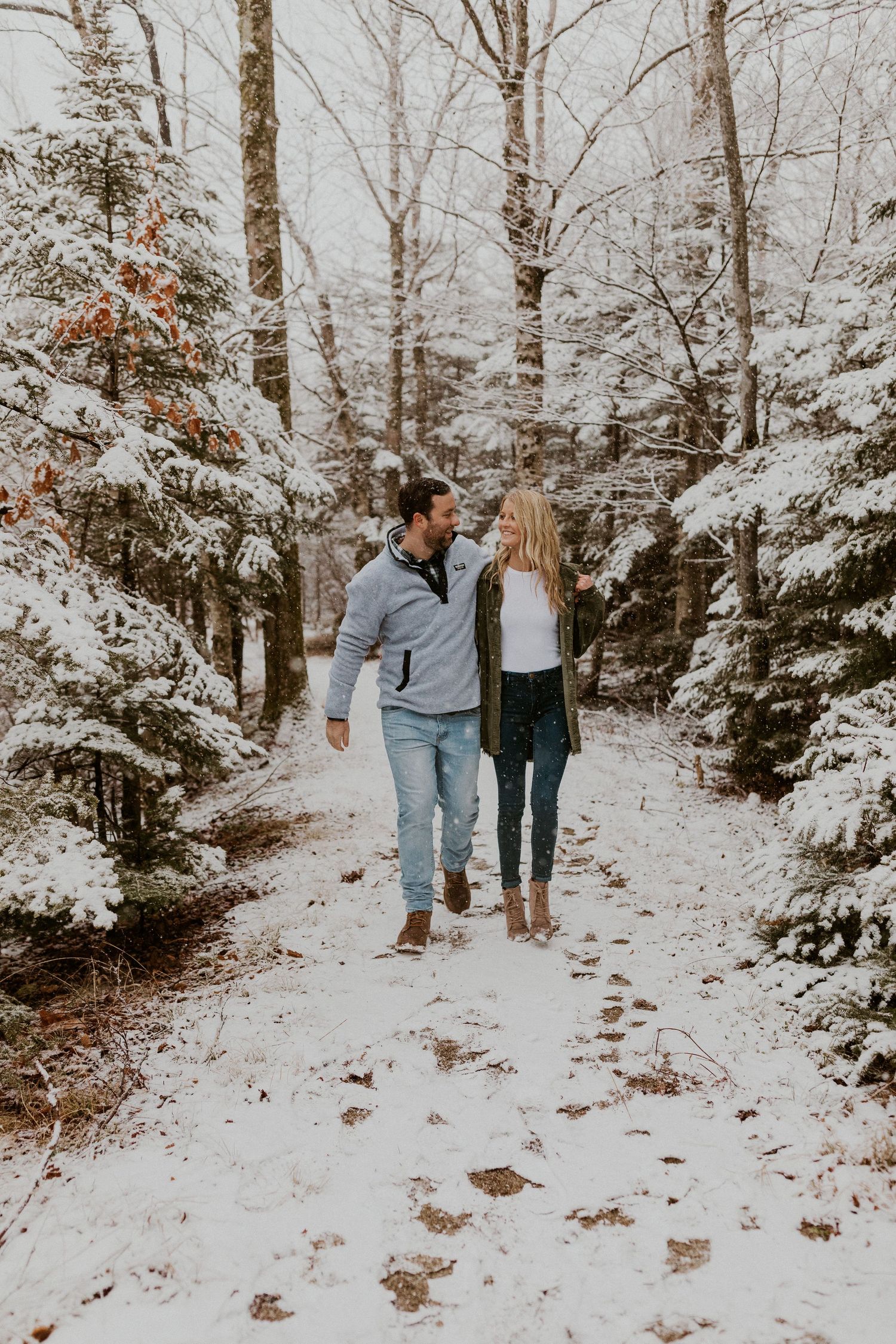 Newly engaged couple playfully posing for photos during their engagement session in Franconia New Hampshire.