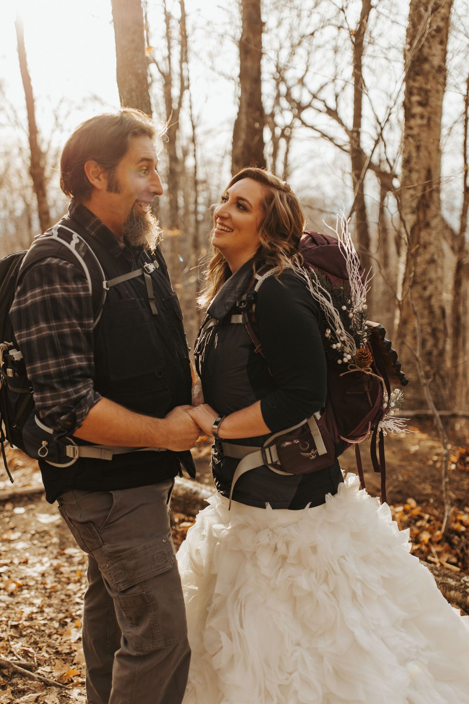 Jackie and Andy Brosonski hike the West Ridge Trail on Mount Cardigan in their wedding attire.