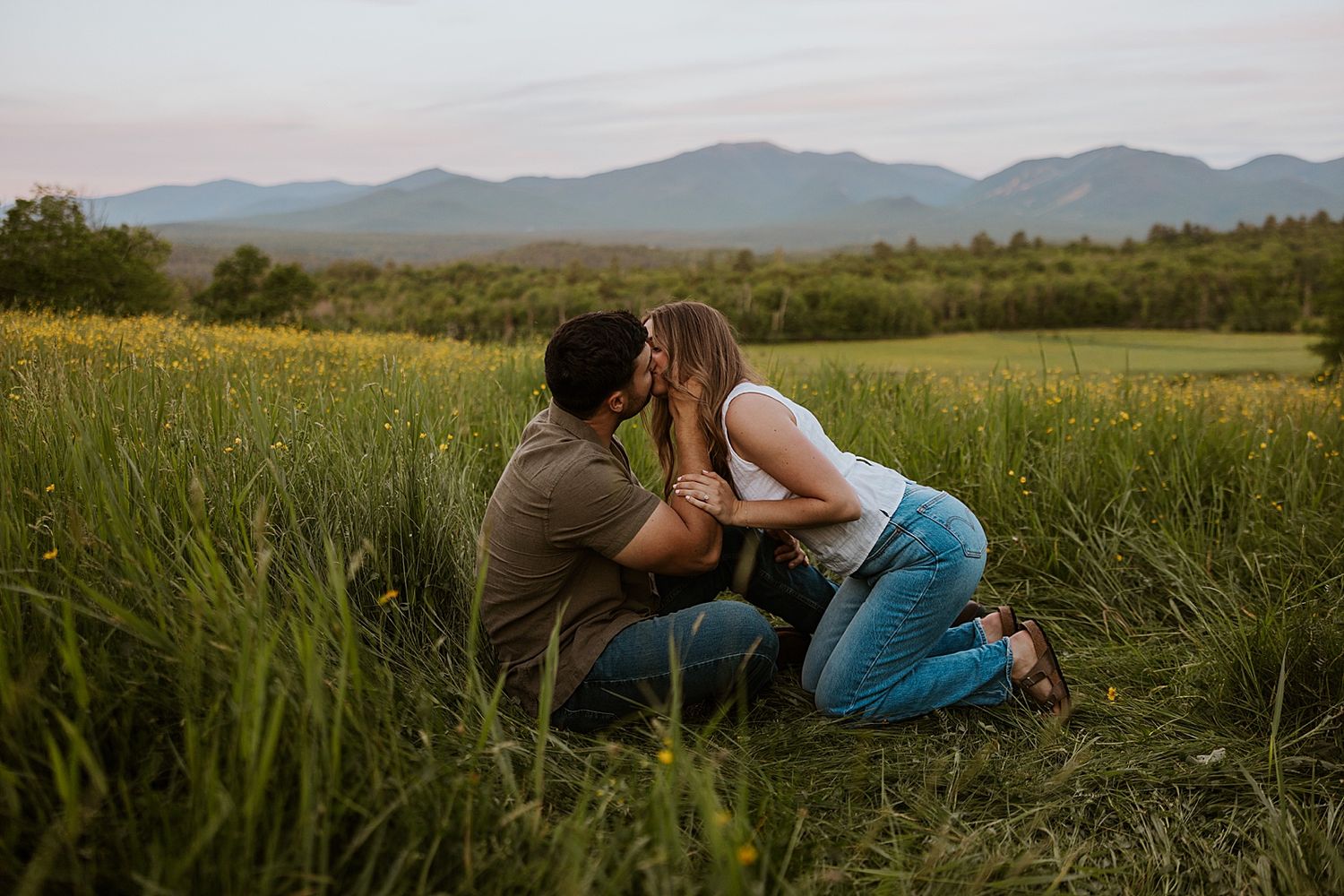 New Hampshire couple taking White Mountain engagement photos in a wildflower field