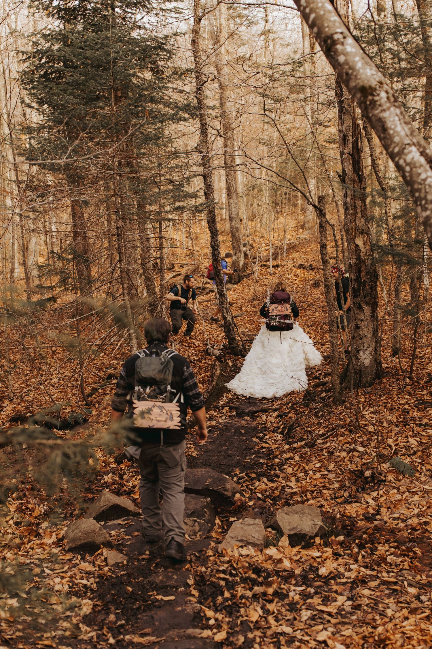Jackie and Andy Brosonski hike the West Ridge Trail on Mount Cardigan in their wedding attire.