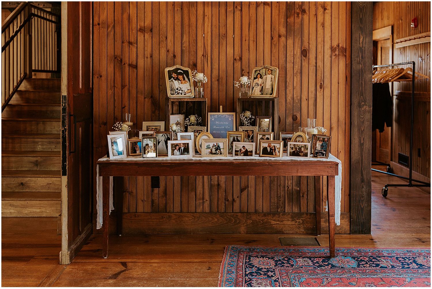 Rustic wooden barn interior with vintage decor and photo frames displayed on wall shelves.