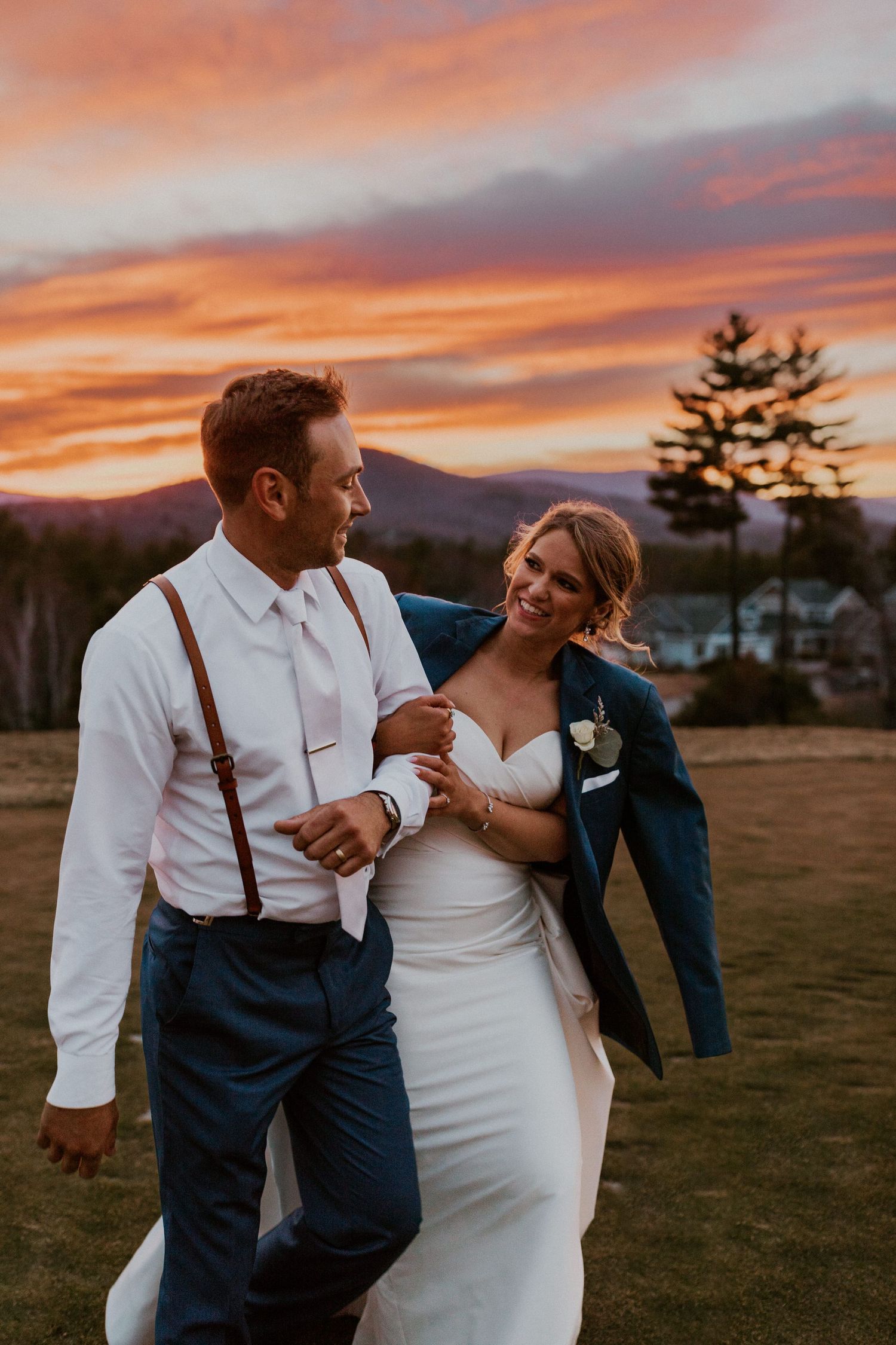 Kendra and Andrew walking away from their wedding day at Owl's Nest Resort together and into the sunset.