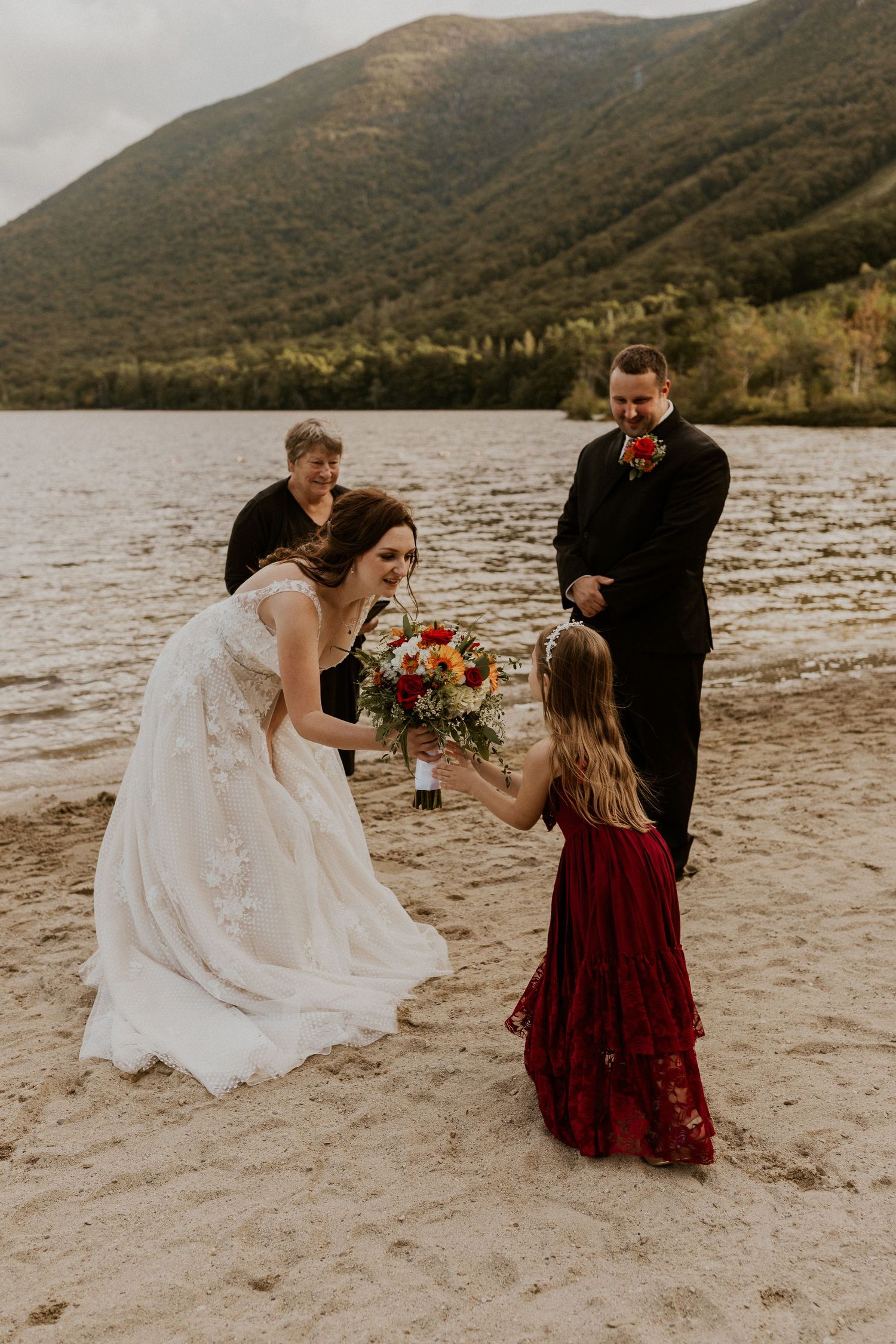 The bride handing her flowers to her daughter just as the elopement ceremony begins.