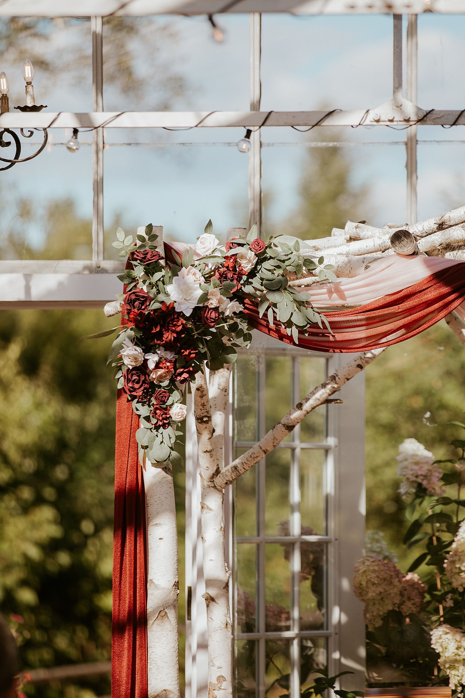 White birch tree arbor decorated with florals for NH wedding ceremony decor