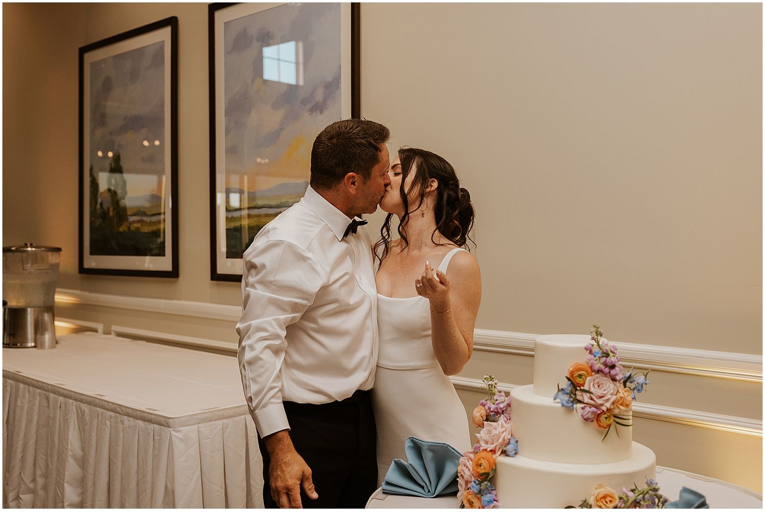 Wedding couple sharing intimate moments in an indoor venue with elegant decor.