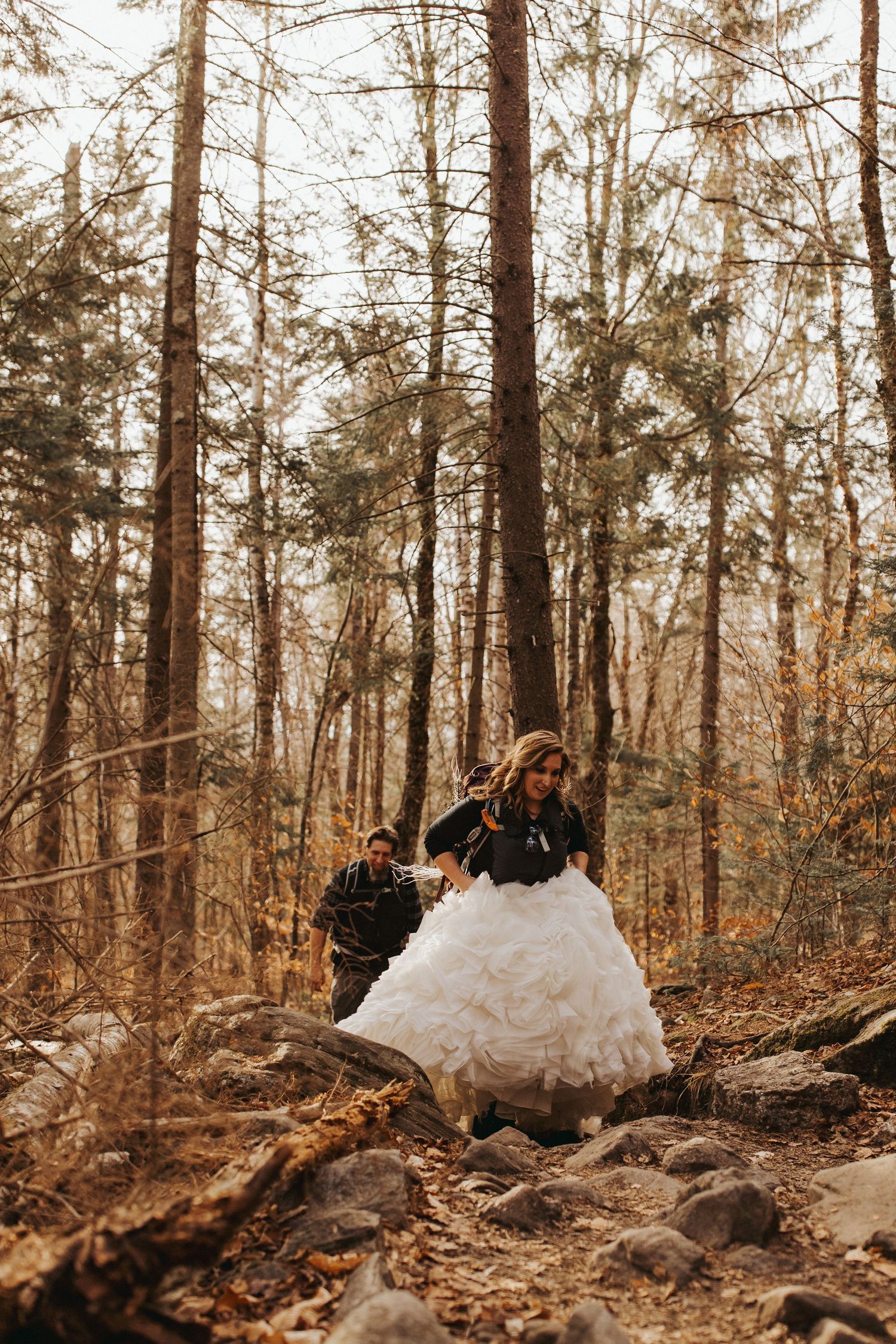 Jackie and Andy Brosonski hike the West Ridge Trail on Mount Cardigan in their wedding attire.