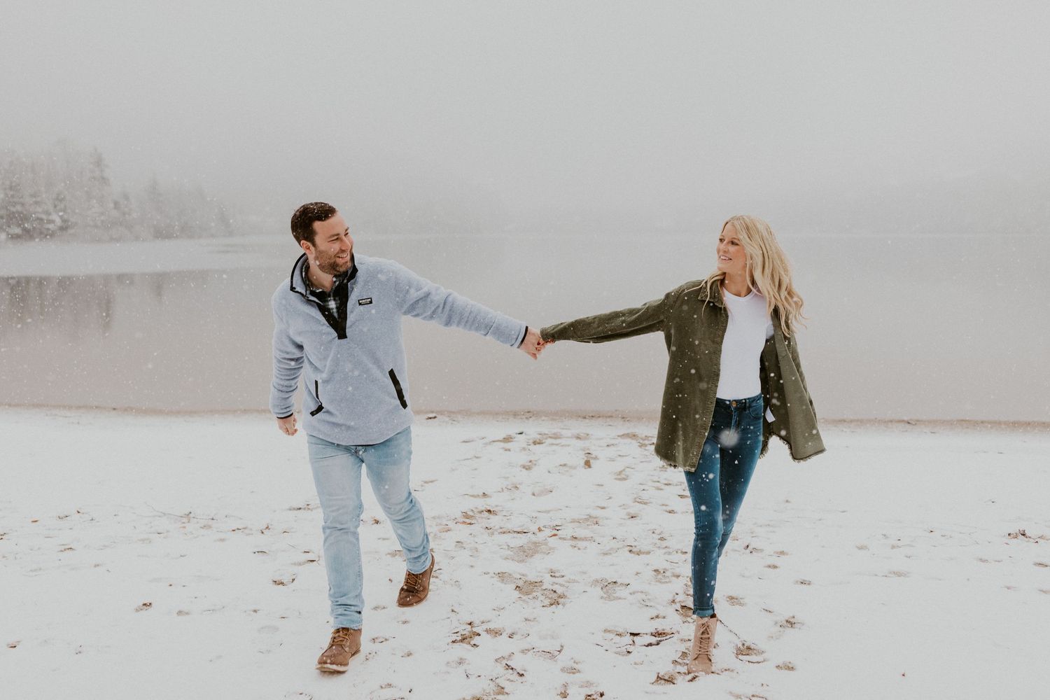 Newly engaged couple playfully posing for photos during their engagement session in Franconia New Hampshire.