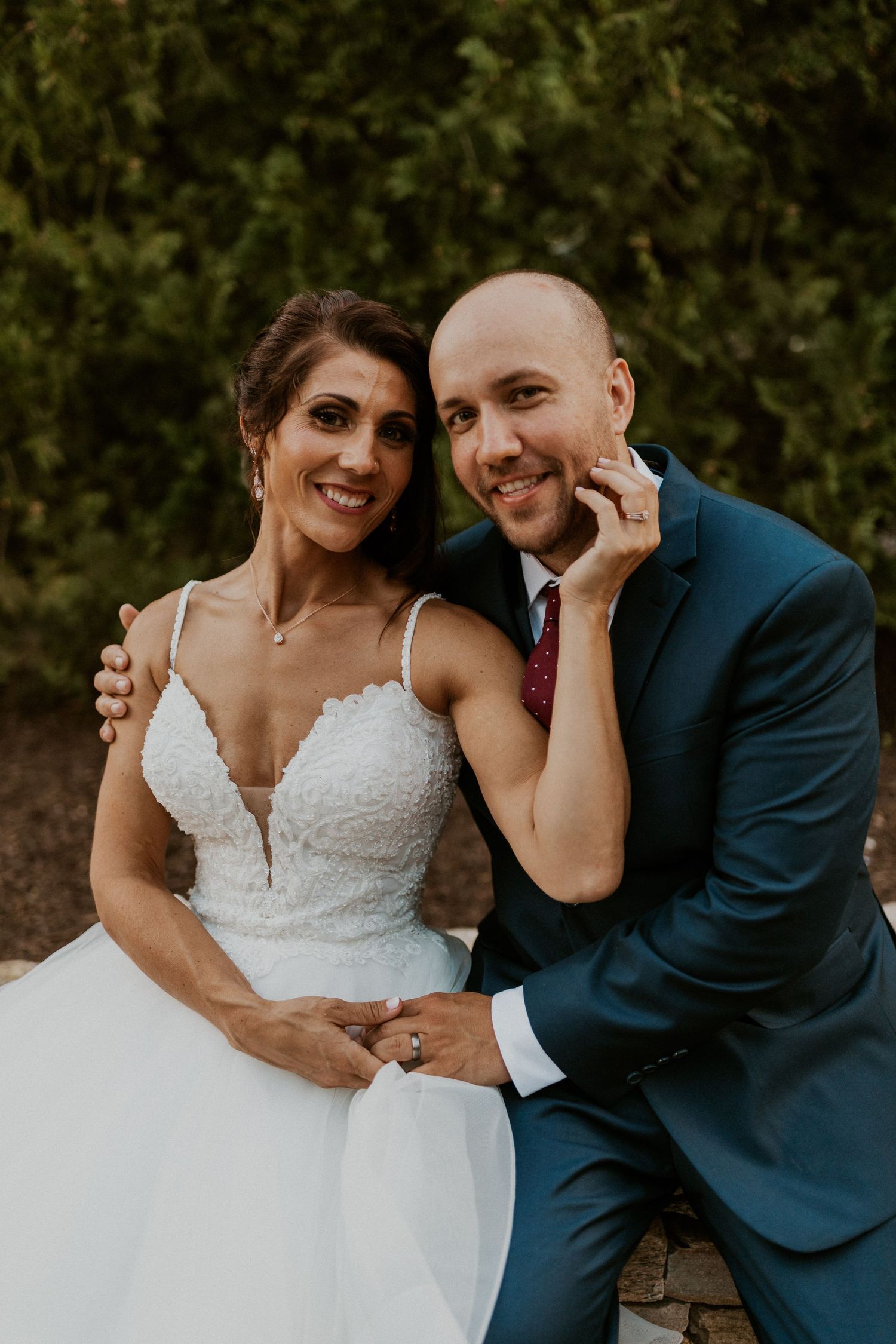 Candid wedding portrait showing joyful laughter between newlyweds.
