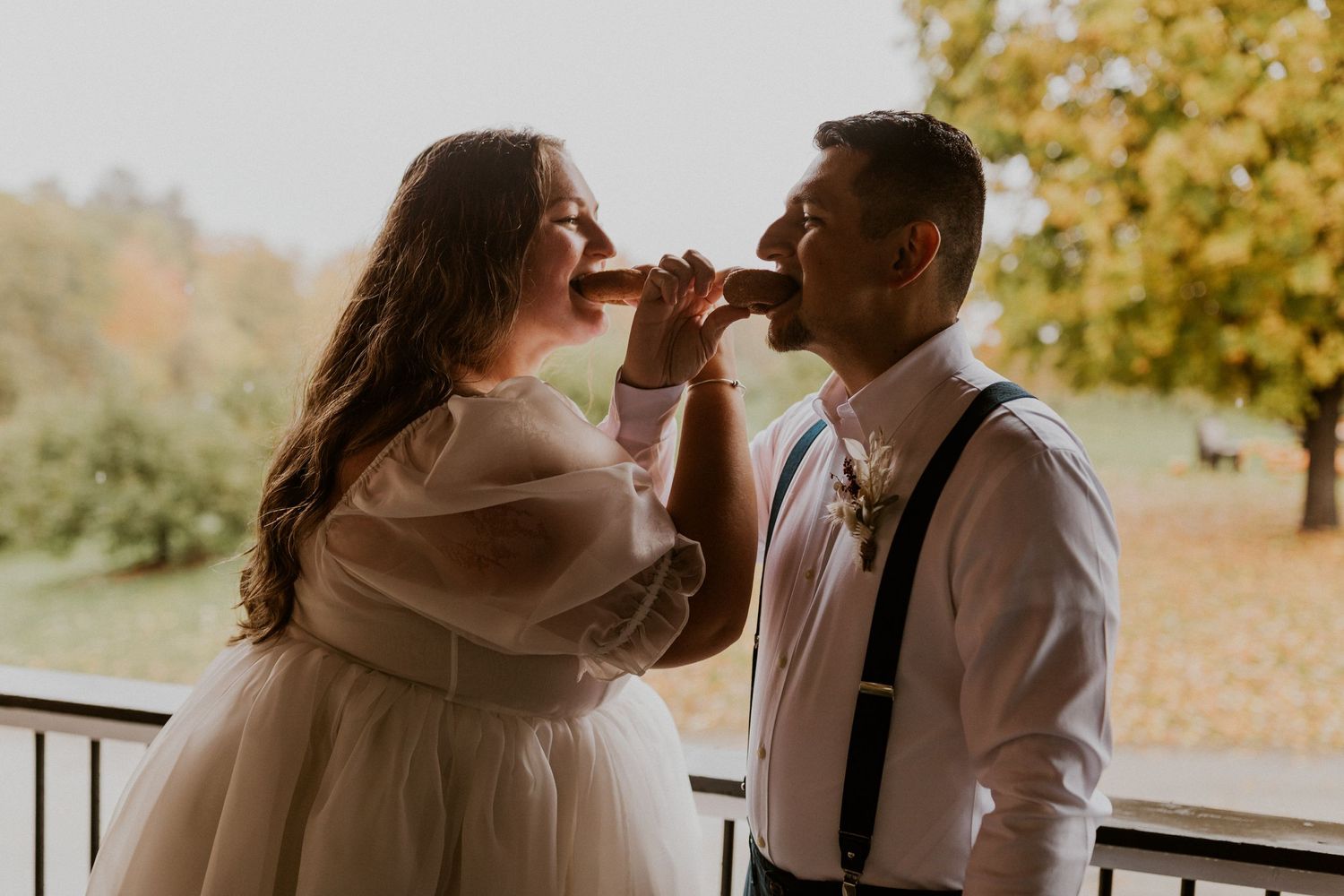 Terise and Jose sharing a donut at Carter Hill Orchard in Concord New Hampshire.
