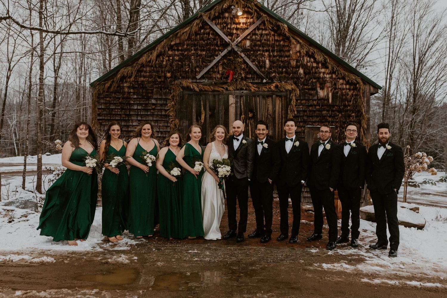 Deirdre and Brodie with their entire wedding party in the background.