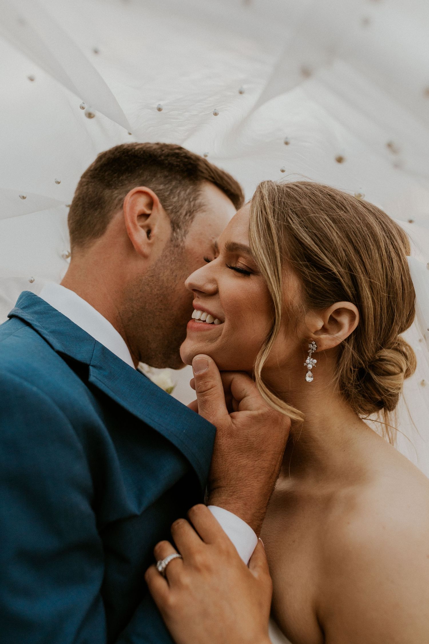 Wedding portrait of Kendra and Andrew under her veil at Owl's Nest Resort in Thornton New Hampshire.
