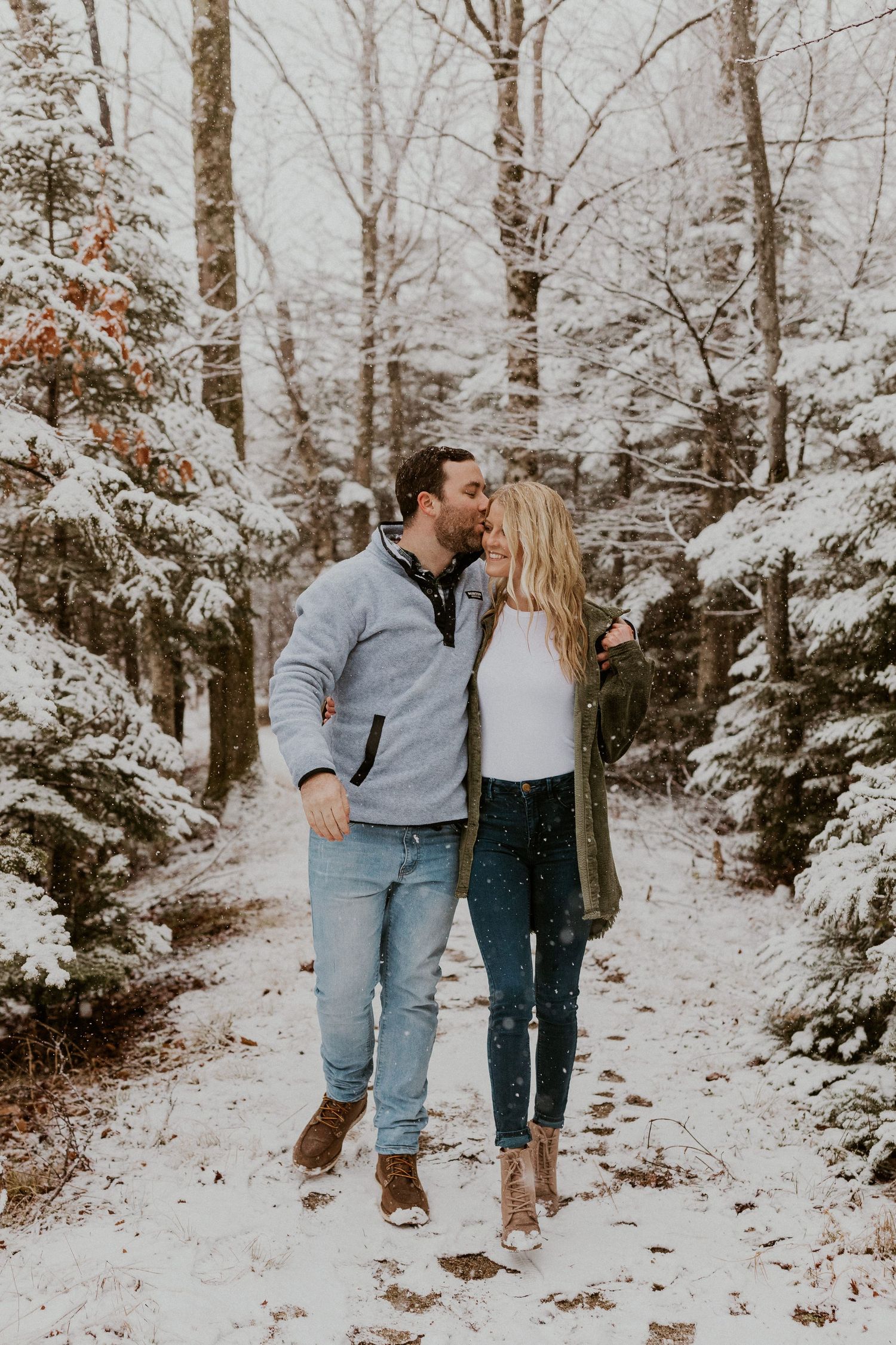 Newly engaged couple playfully posing for photos during their engagement session in Franconia New Hampshire.
