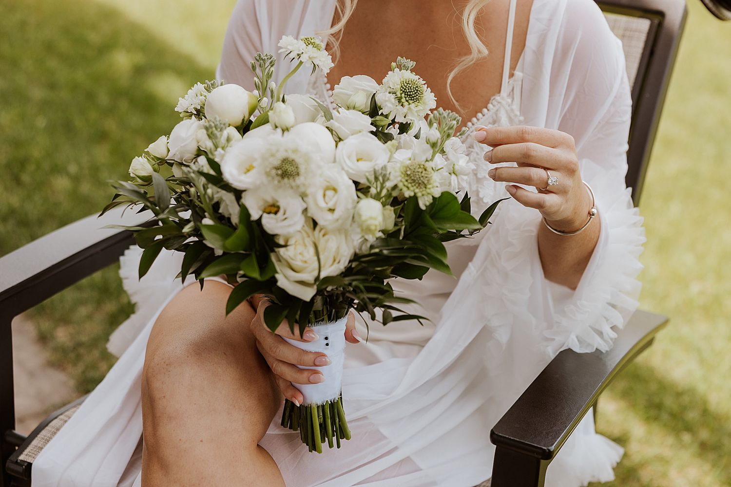 Bride in her robe holding her bouquet getting ready for her Owl's Nest Resort wedding in NH