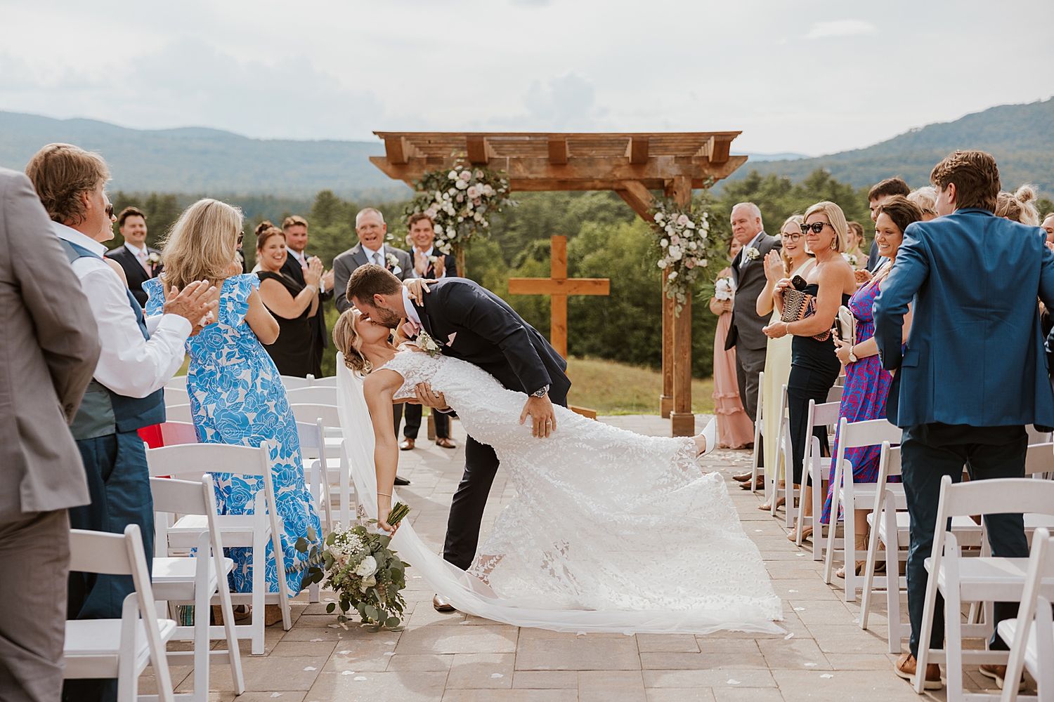 Bride and groom kissing after their outdoor wedding ceremony at the Sunset Pavilion at the Owl's Nest Resort in New Hampshire