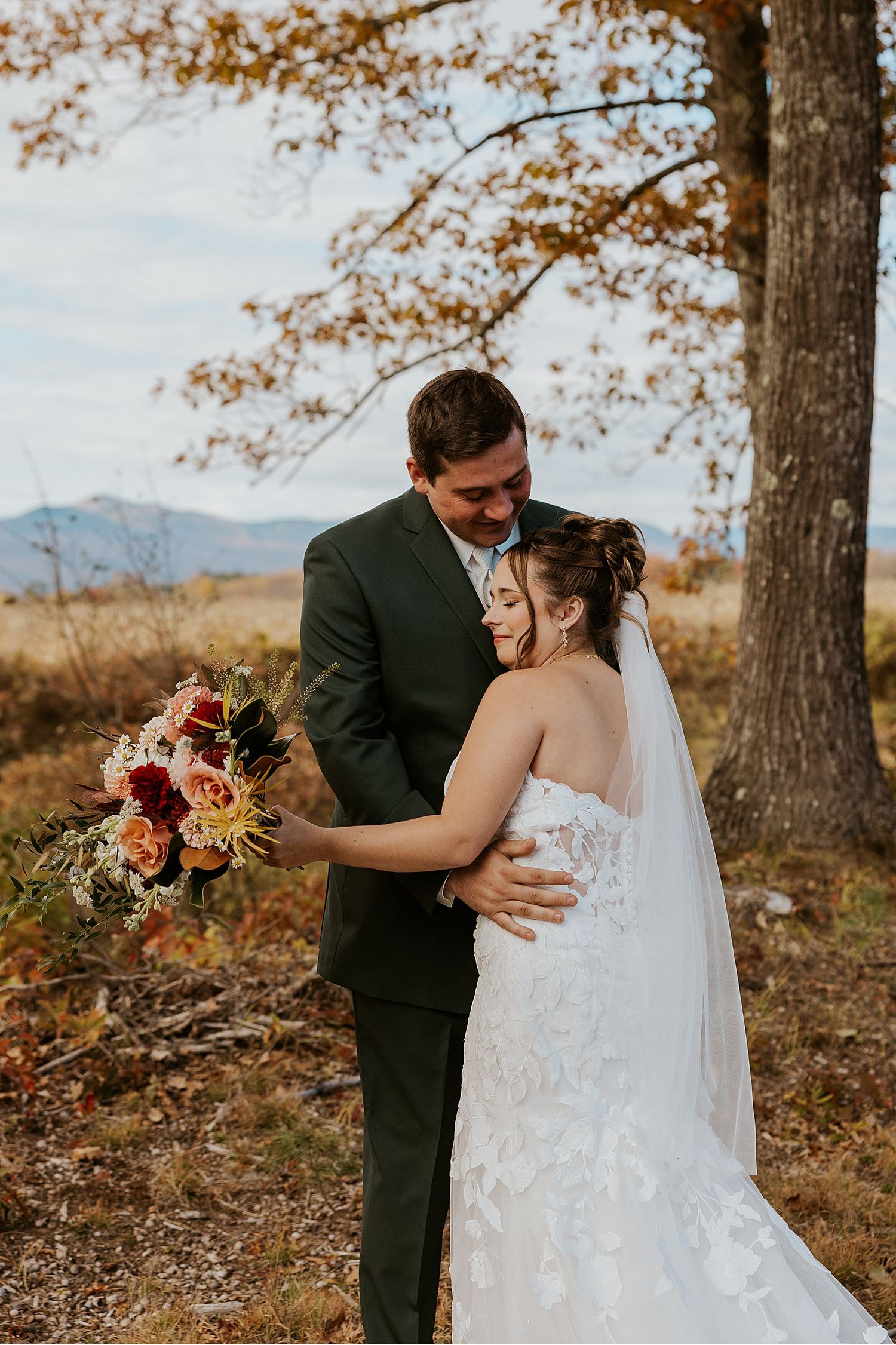 Bride and groom taking portrait photos at their Maine fall wedding