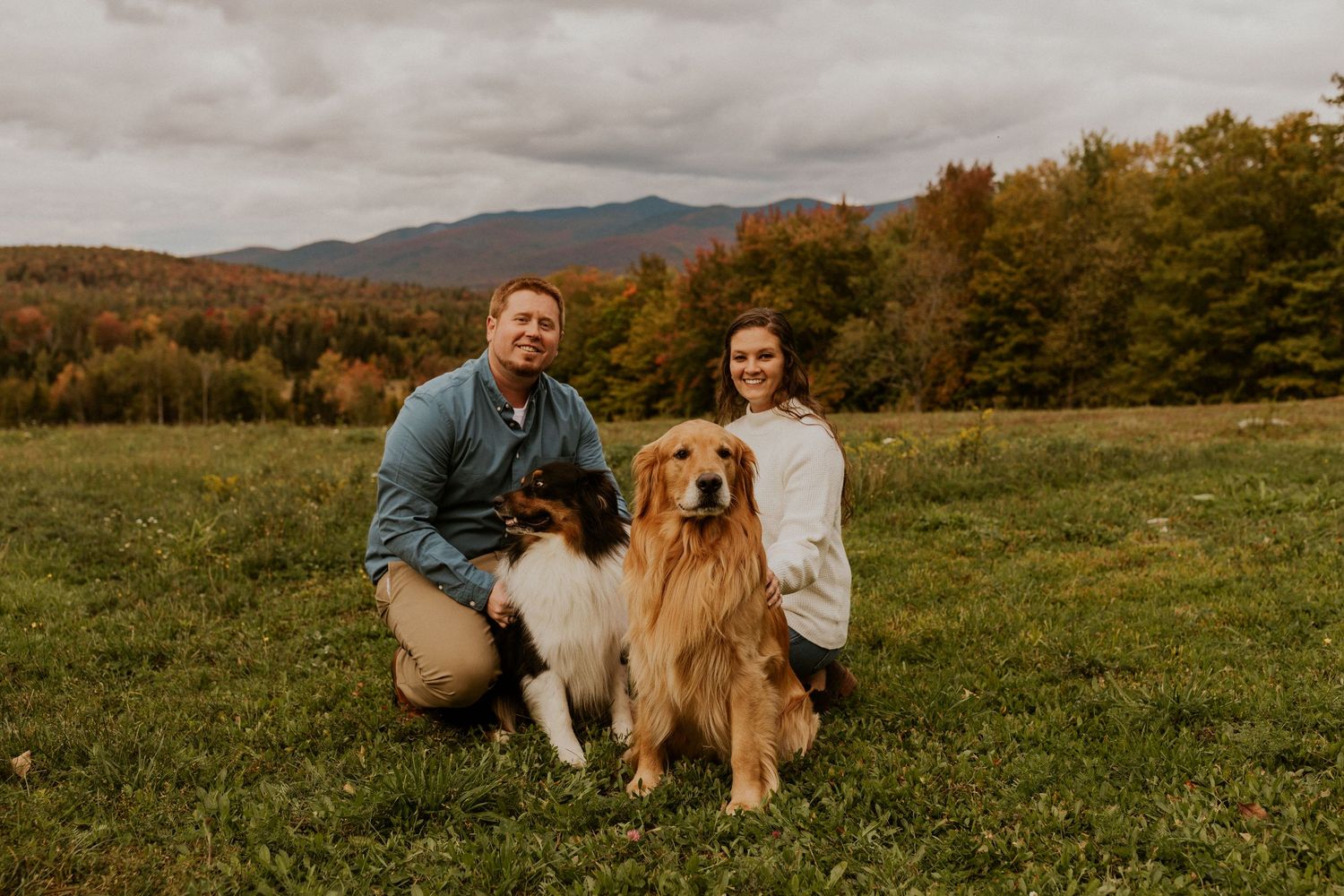 Paige and Michael posing for a portrait with their dogs in the twin mountain region of New Hampshire.