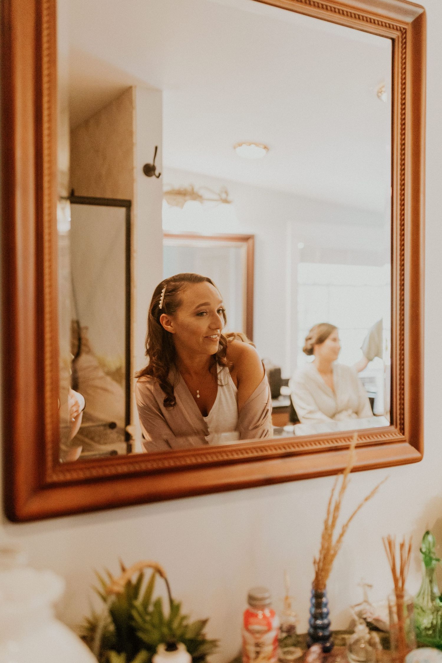 Chrissy looking at her wedding style in the mirror!