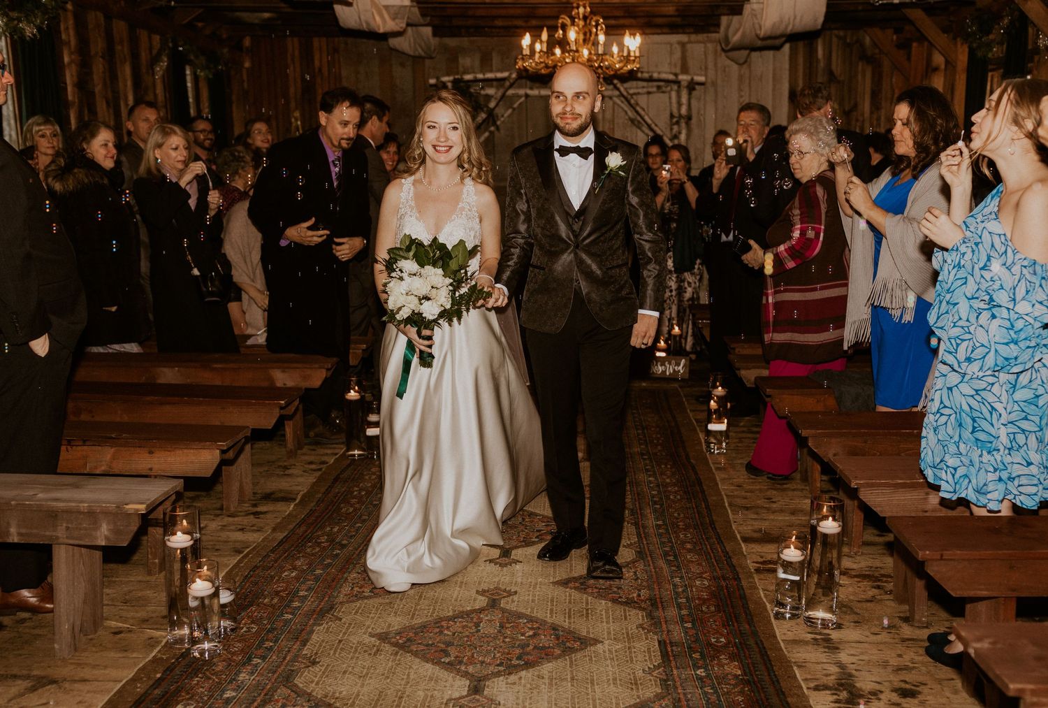 Deirdre and Brodie walking out from their wedding ceremony hand in hand.