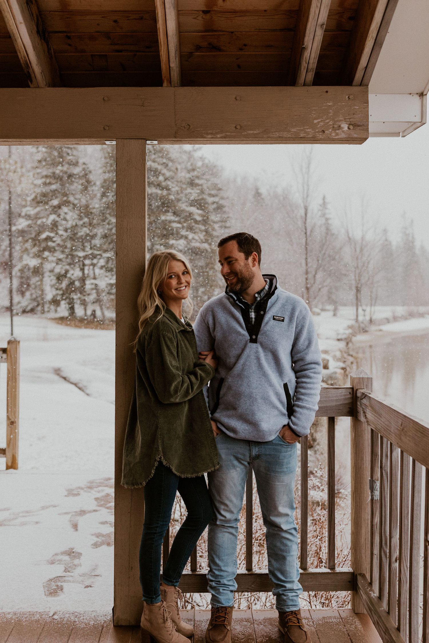 Newly engaged couple playfully posing for photos during their engagement session in Franconia New Hampshire.