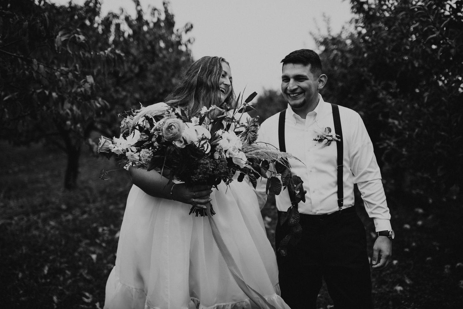 Terise and Jose walking through Carter Hill Orchard on a rainy October day.