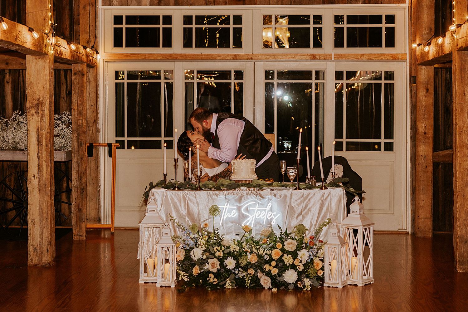 Couple kissing at their wedding reception at the Barn at Powder Major's Farm