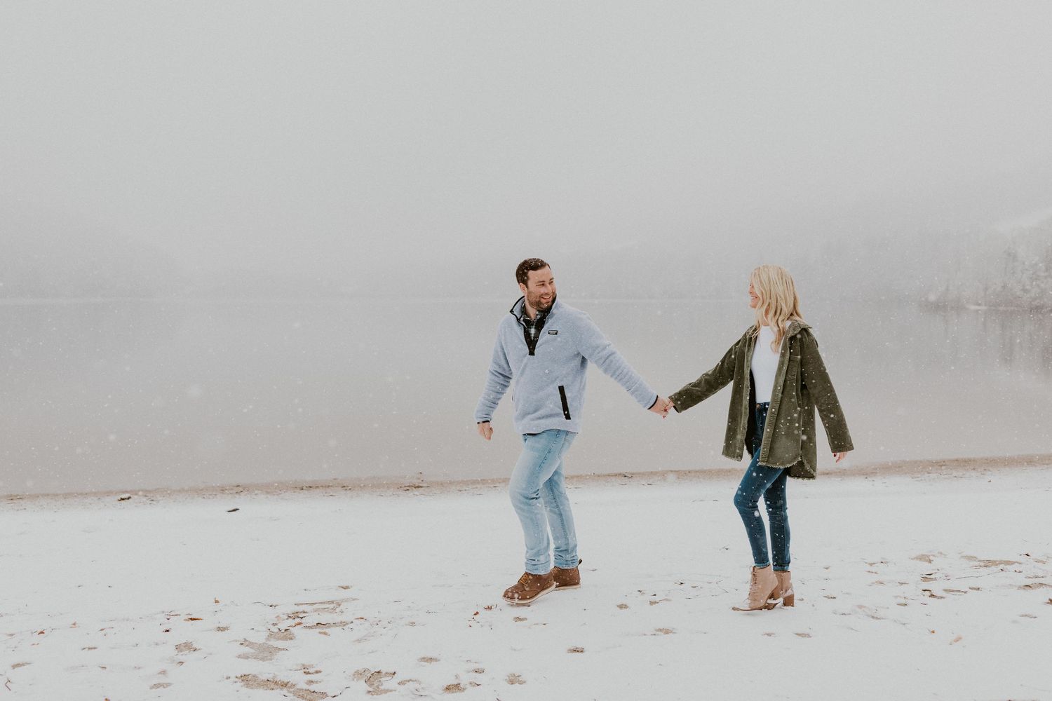 Newly engaged couple playfully posing for photos during their engagement session in Franconia New Hampshire.